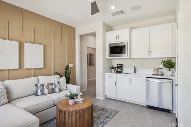 a living room with furniture a fireplace and a sink