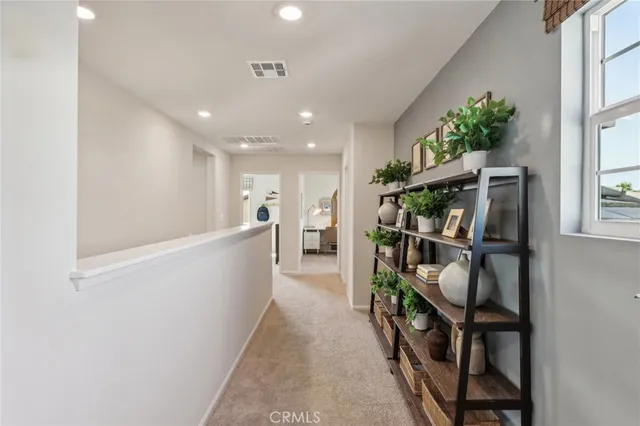 a living room with furniture and a book shelf