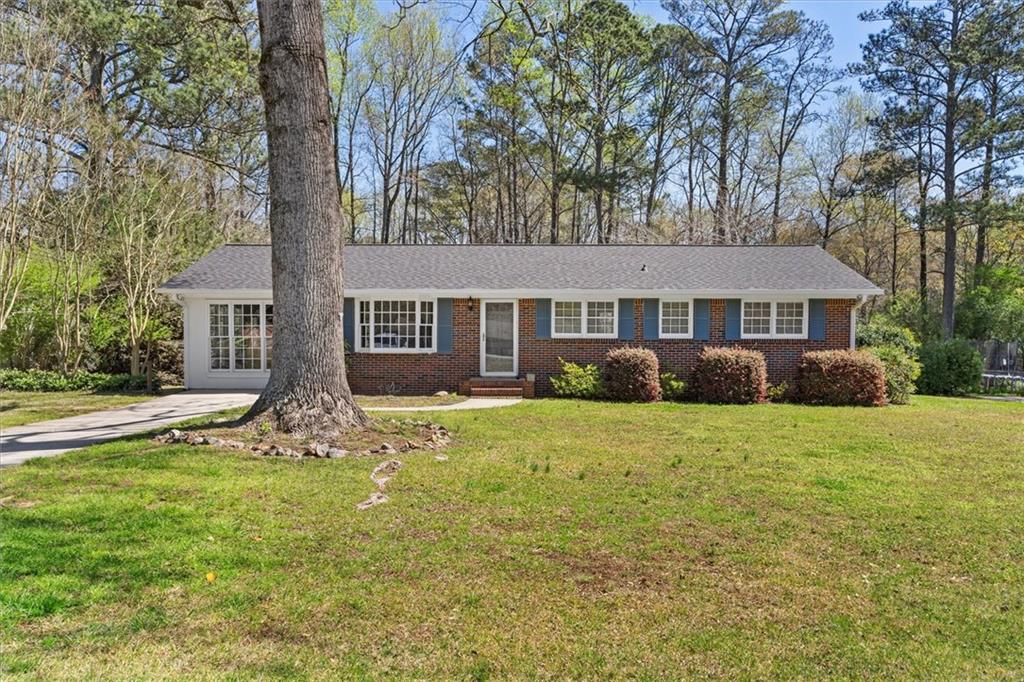1211 Roscoe Road Newnan, GA 30263 - Photo 1 of 1 a front view of a house with garden