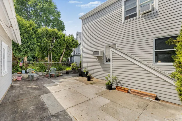 a view of a house with backyard and sitting area