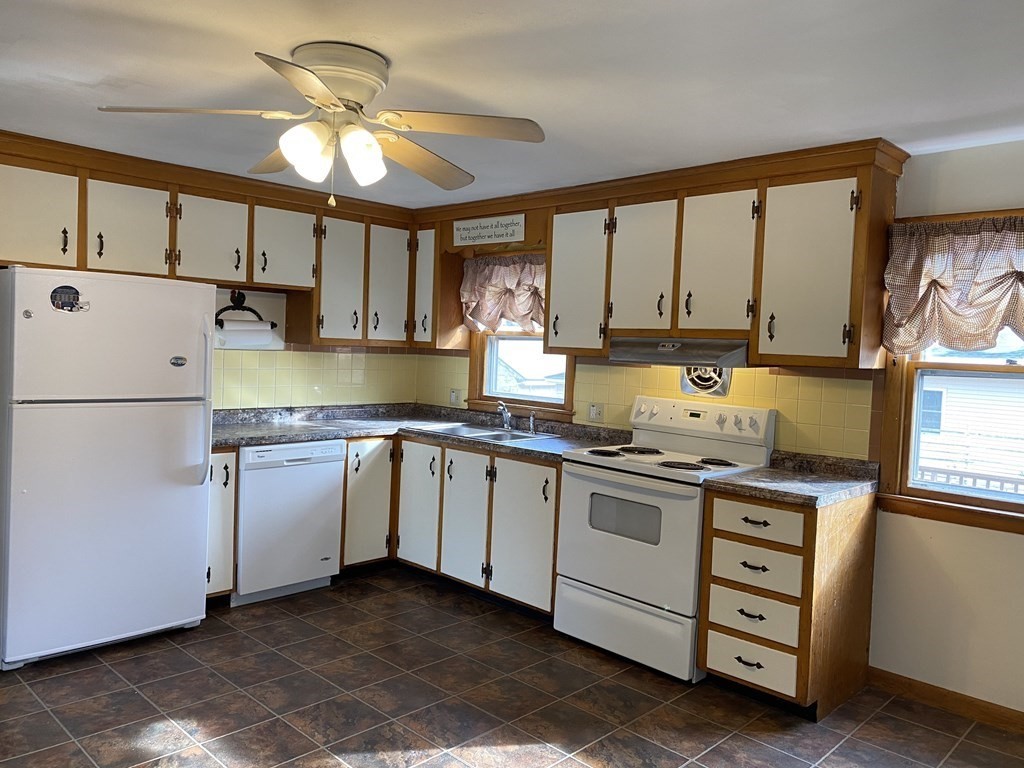 92 Hally Road Lowell, MA 01854 - Photo 6 of 36 a kitchen with granite countertop white cabinets and white appliances