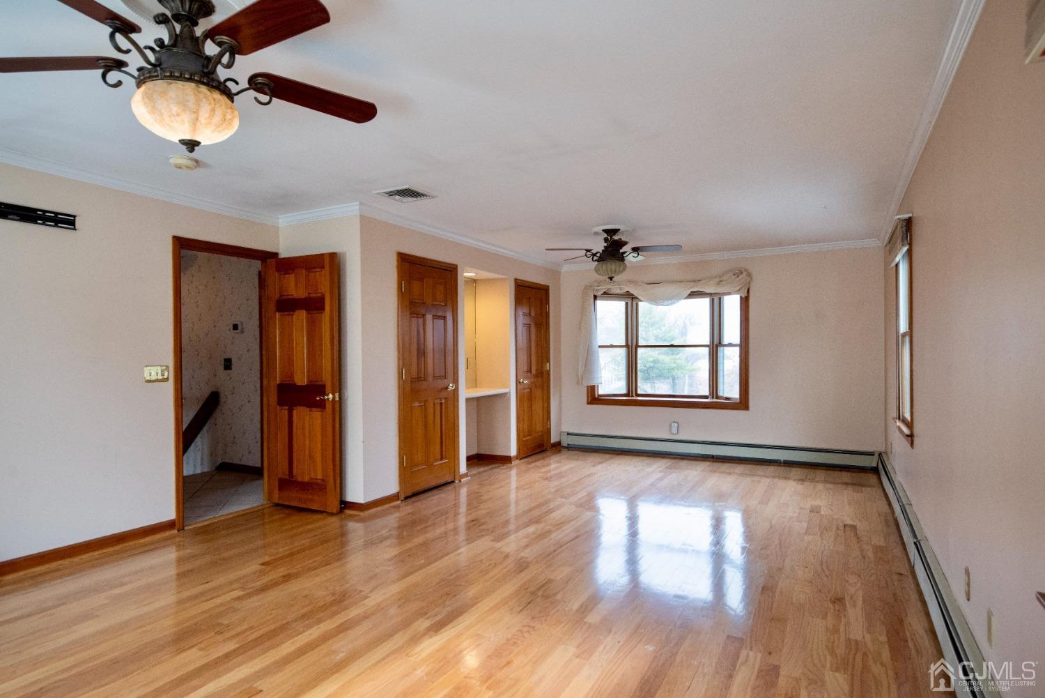 115 New Brooklyn Road Edison, NJ 08817 - Photo 24 of 53 a view of empty room with wooden floor and fan