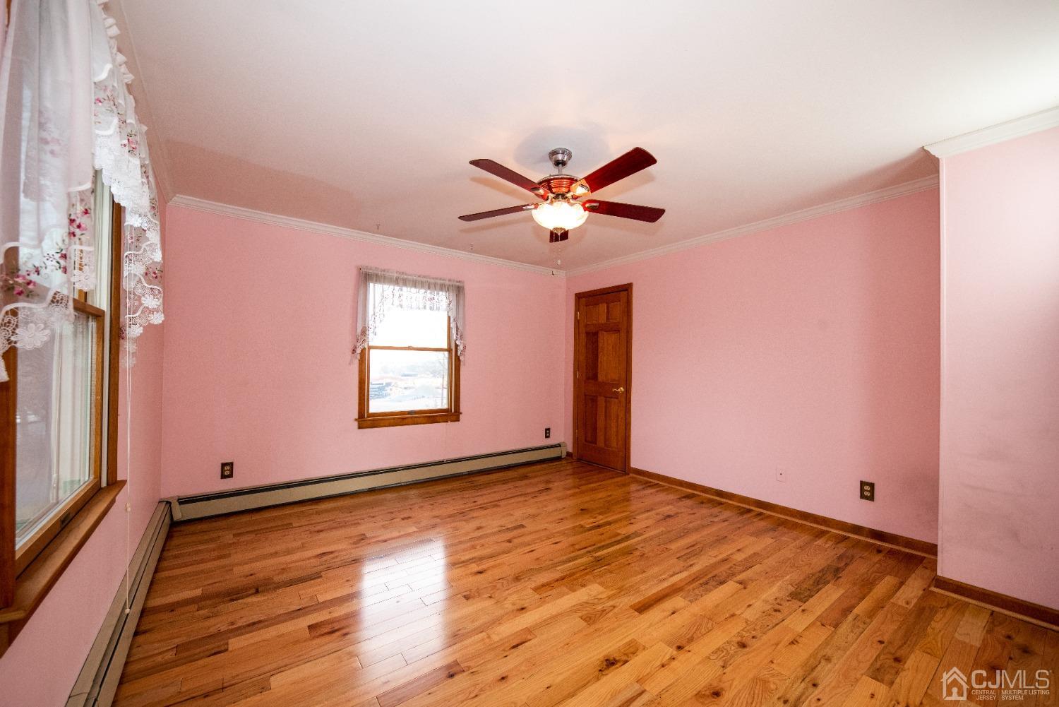 115 New Brooklyn Road Edison, NJ 08817 - Photo 41 of 53 a view of an empty room with window and wooden floor
