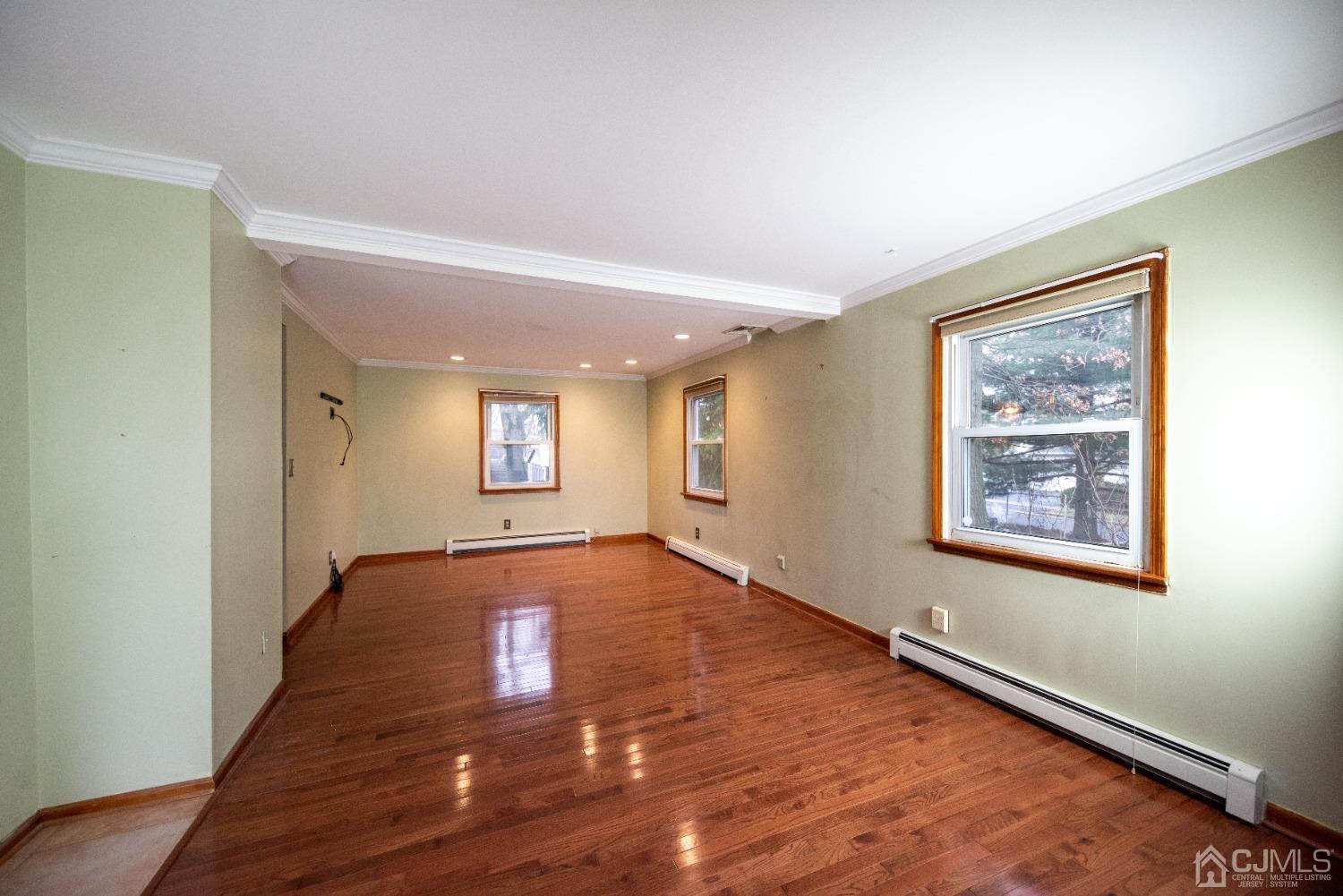 115 New Brooklyn Road Edison, NJ 08817 - Photo 6 of 53 a view of an empty room with window and wooden floor