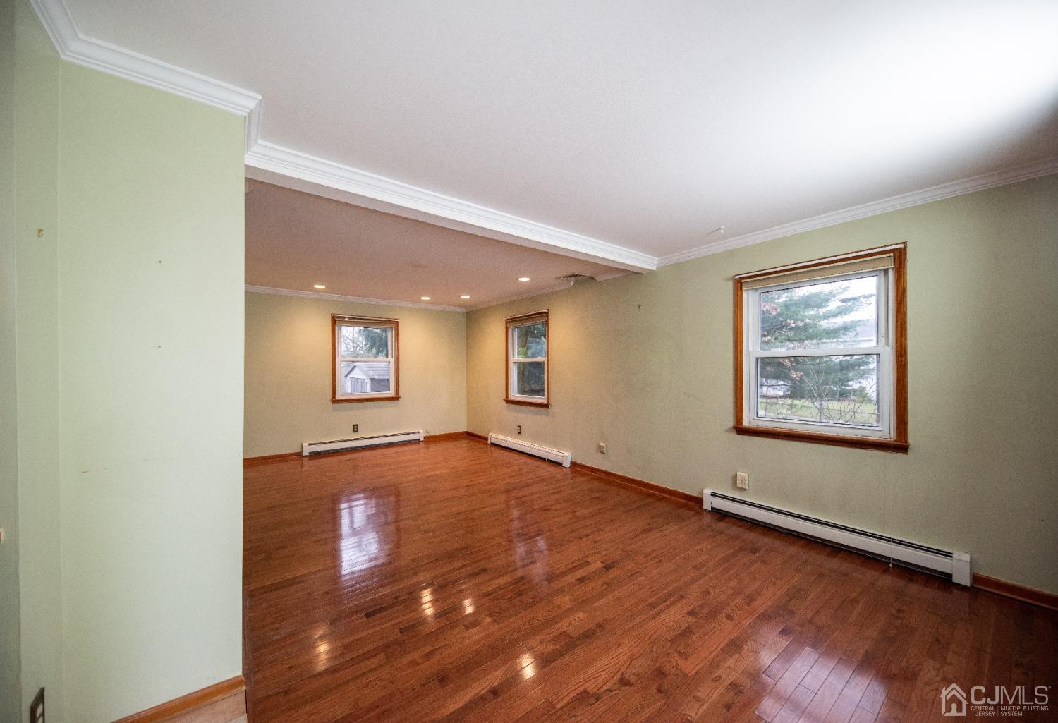 115 New Brooklyn Road Edison, NJ 08817 - Photo 7 of 53 an empty room with wooden floor and windows