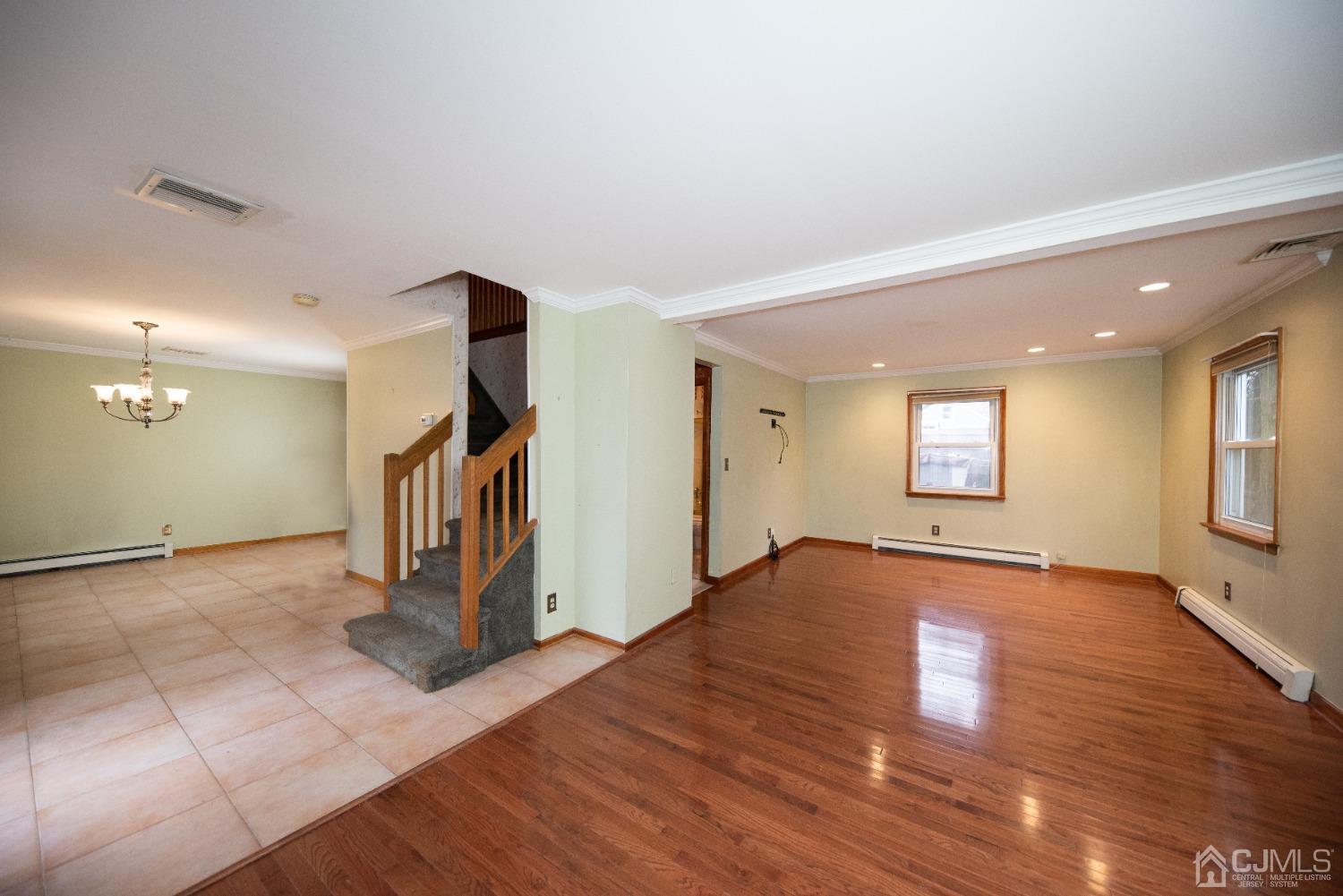 115 New Brooklyn Road Edison, NJ 08817 - Photo 8 of 53 a view of an empty room with window and wooden floor