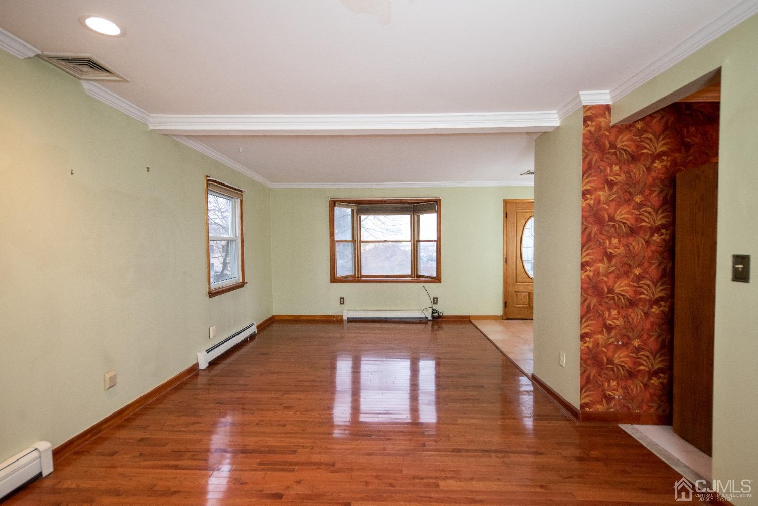 115 New Brooklyn Road Edison, NJ 08817 - Photo 9 of 53 an empty room with wooden floor and windows