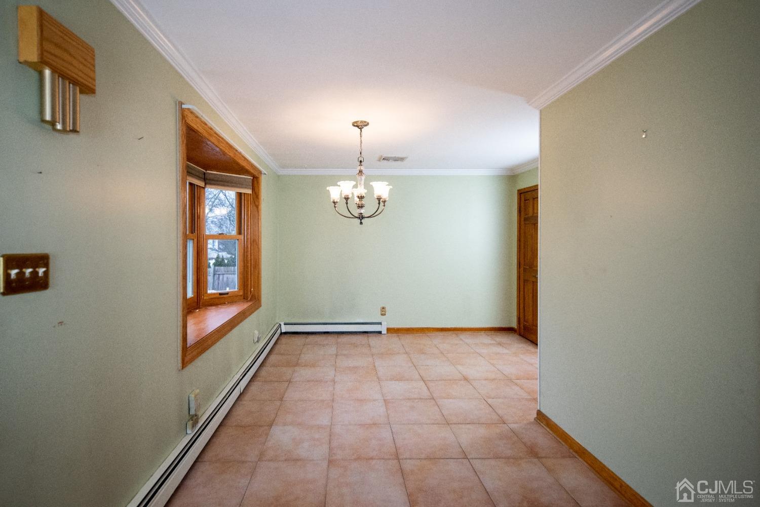 115 New Brooklyn Road Edison, NJ 08817 - Photo 10 of 53 a view of an empty room with window and chandelier fan