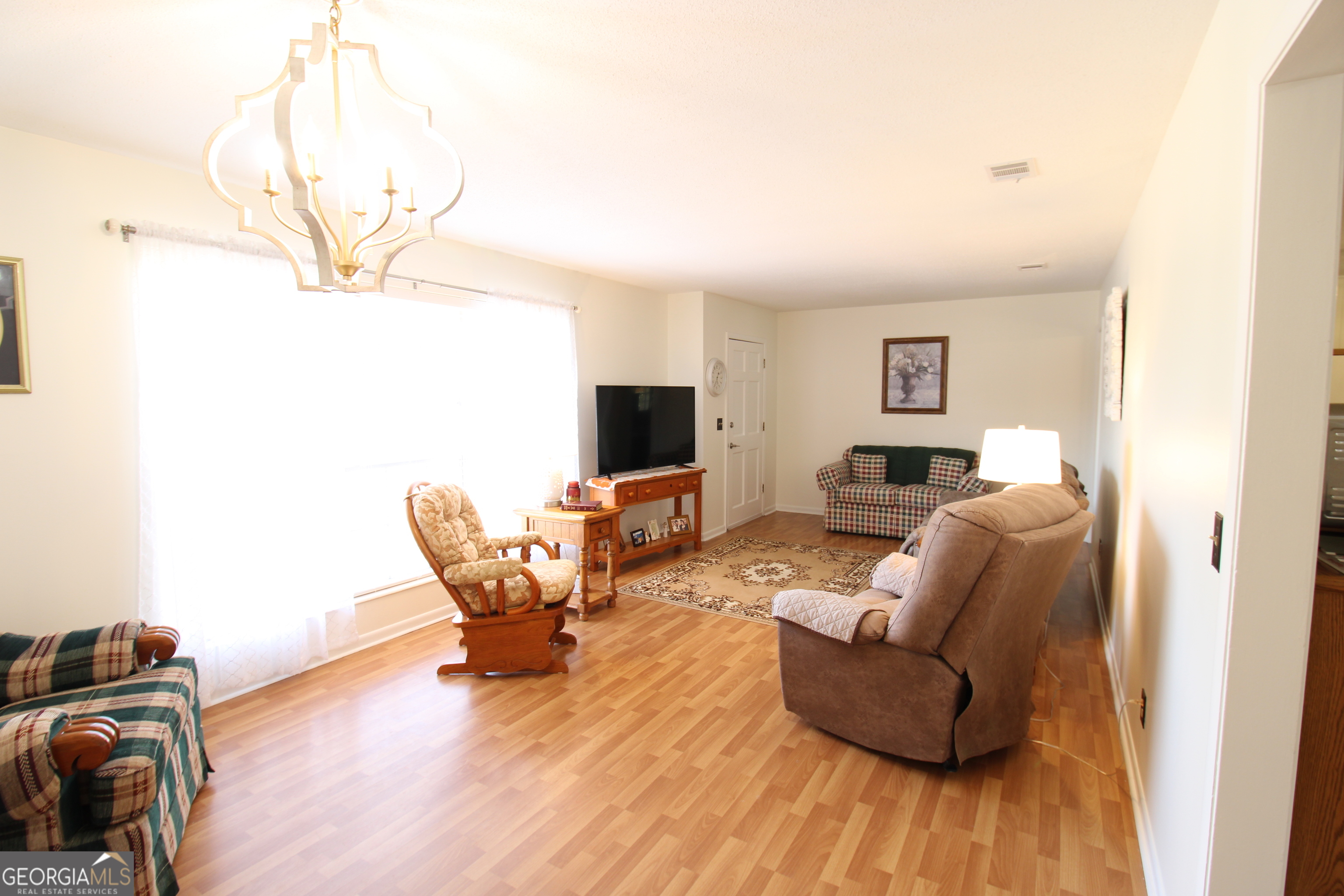 2337 Spring Street Waycross, GA 31503 - Photo 11 of 28 a living room with furniture and a flat screen tv