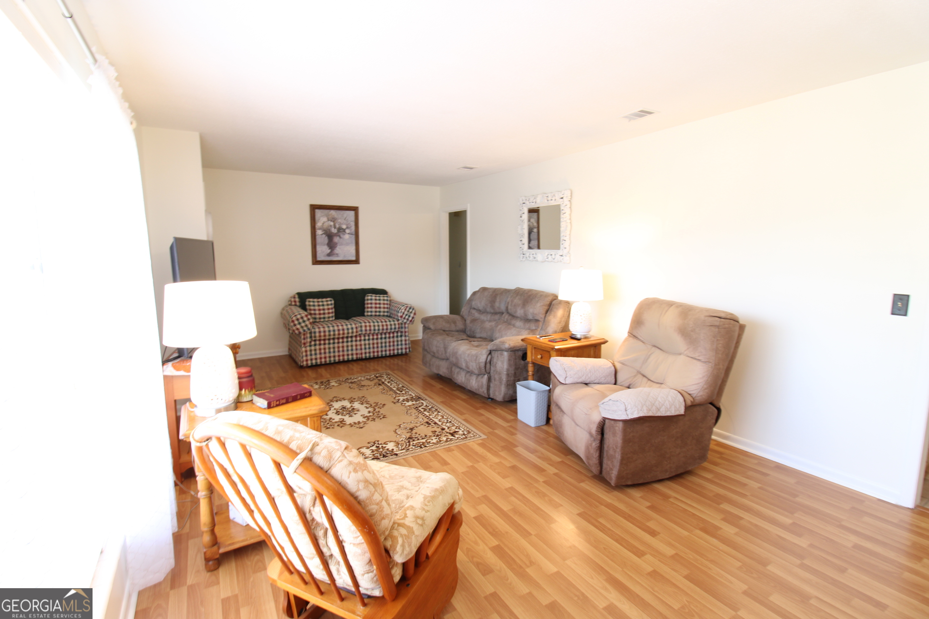 2337 Spring Street Waycross, GA 31503 - Photo 12 of 28 a bedroom with furniture and a wooden floor