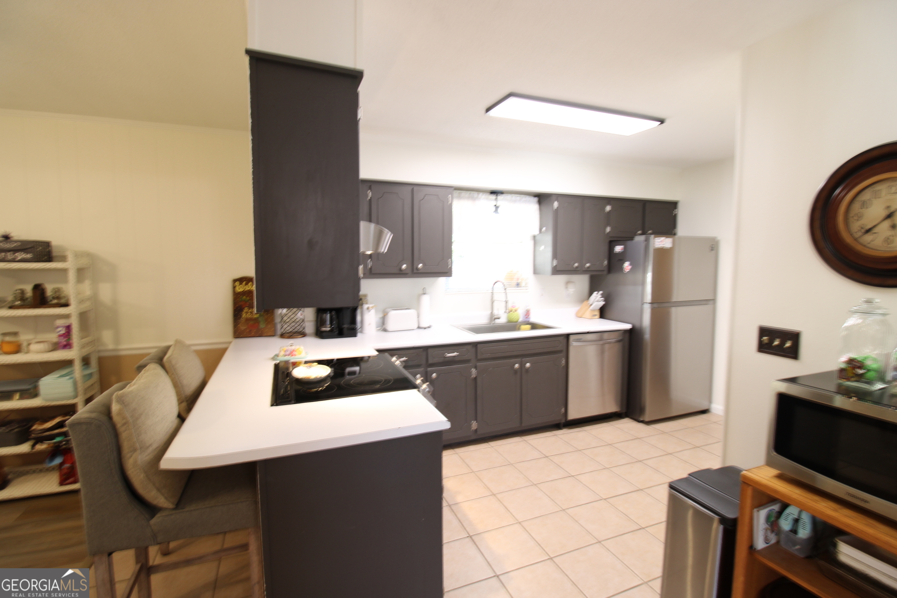 2337 Spring Street Waycross, GA 31503 - Photo 13 of 28 a kitchen with a table chairs a stove a refrigerator and cabinets