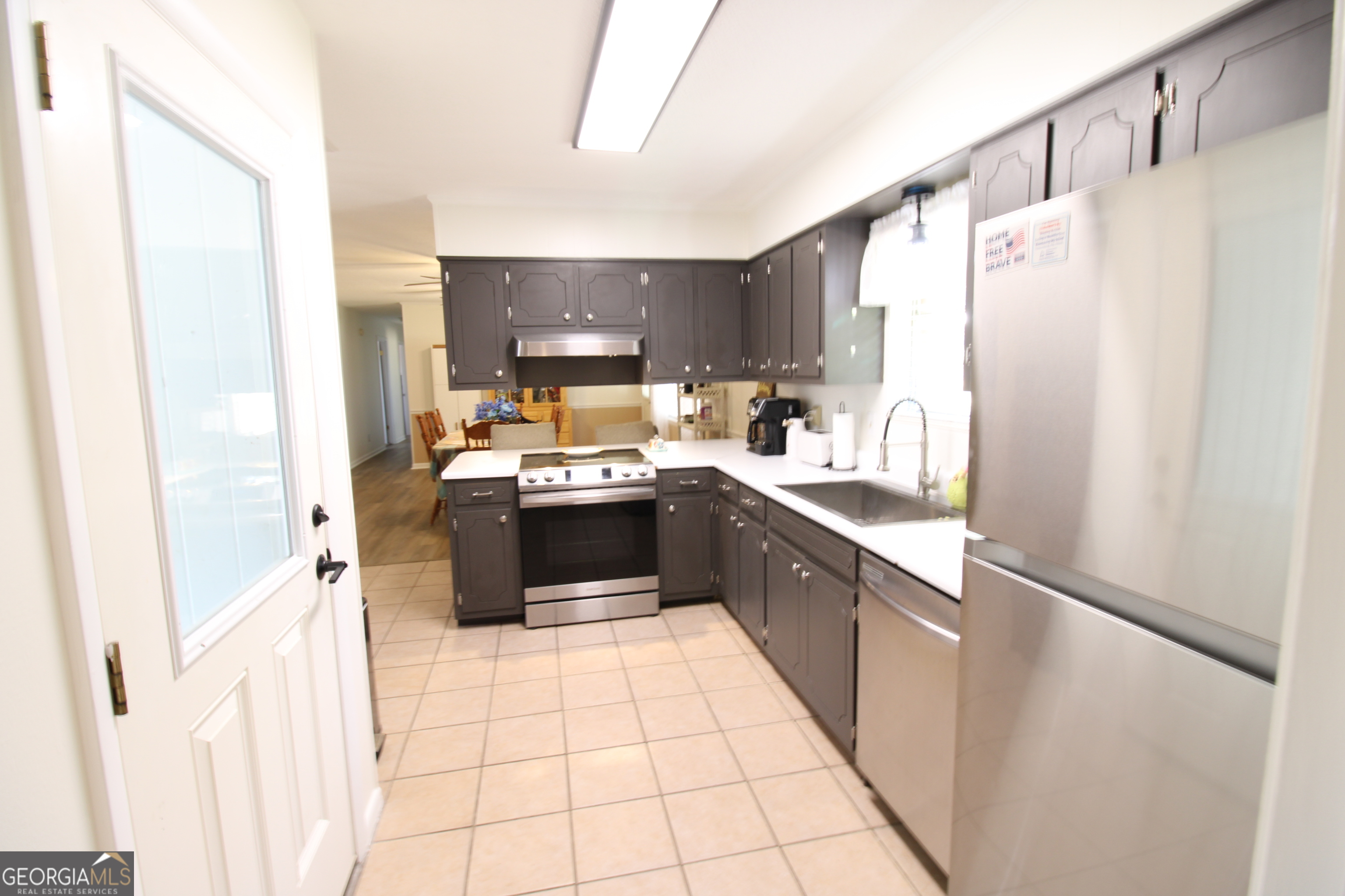 2337 Spring Street Waycross, GA 31503 - Photo 14 of 28 a kitchen with stainless steel appliances a refrigerator sink and cabinets
