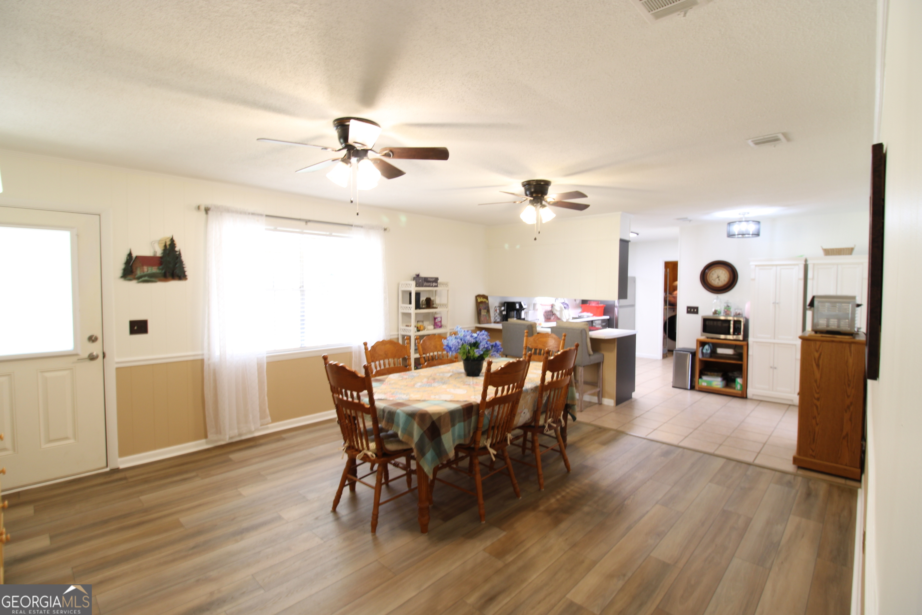 2337 Spring Street Waycross, GA 31503 - Photo 16 of 28 a view of a dining room with furniture and wooden floor