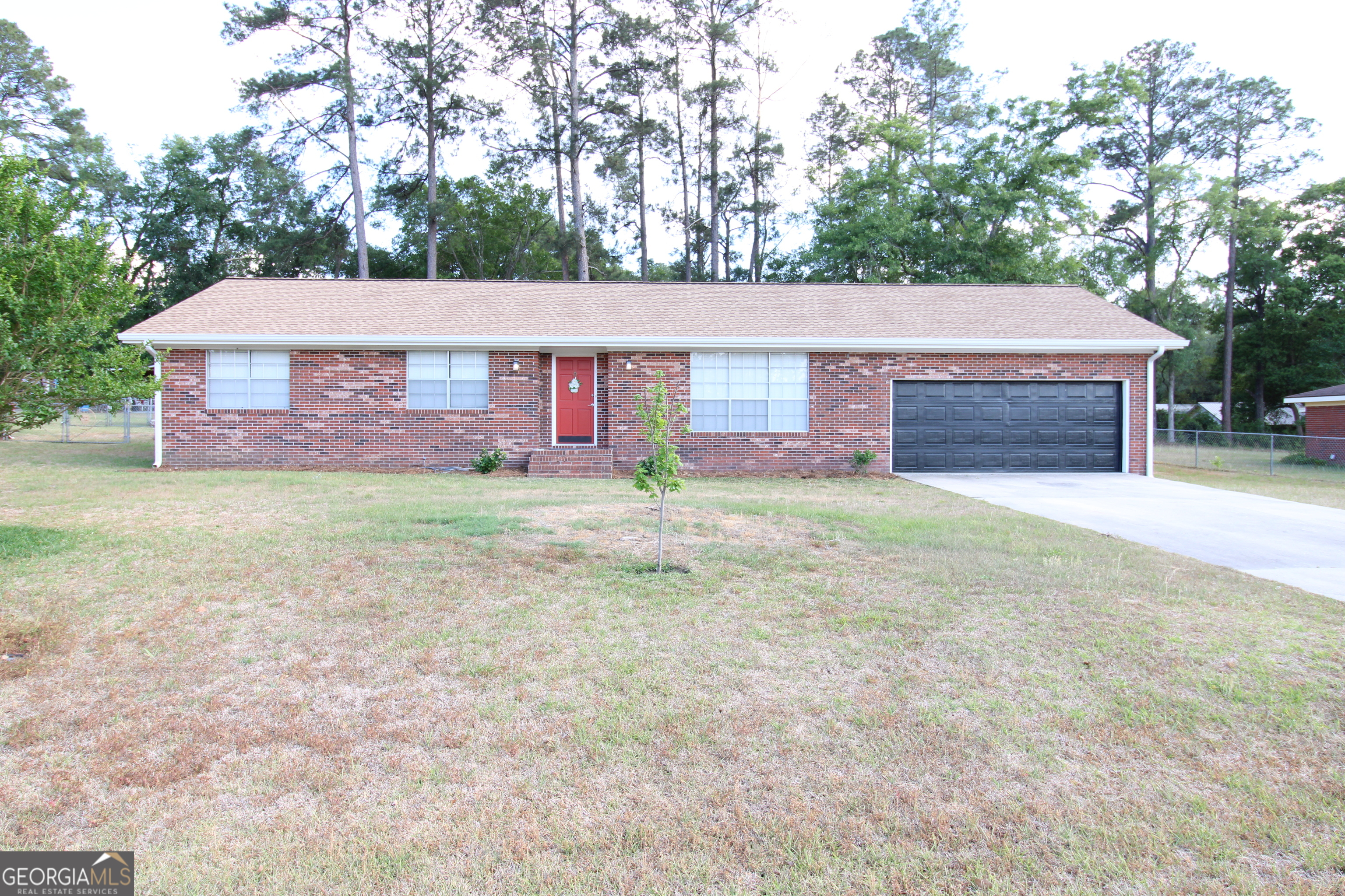 2337 Spring Street Waycross, GA 31503 - Photo 2 of 28 a front view of house with yard and trees in the background