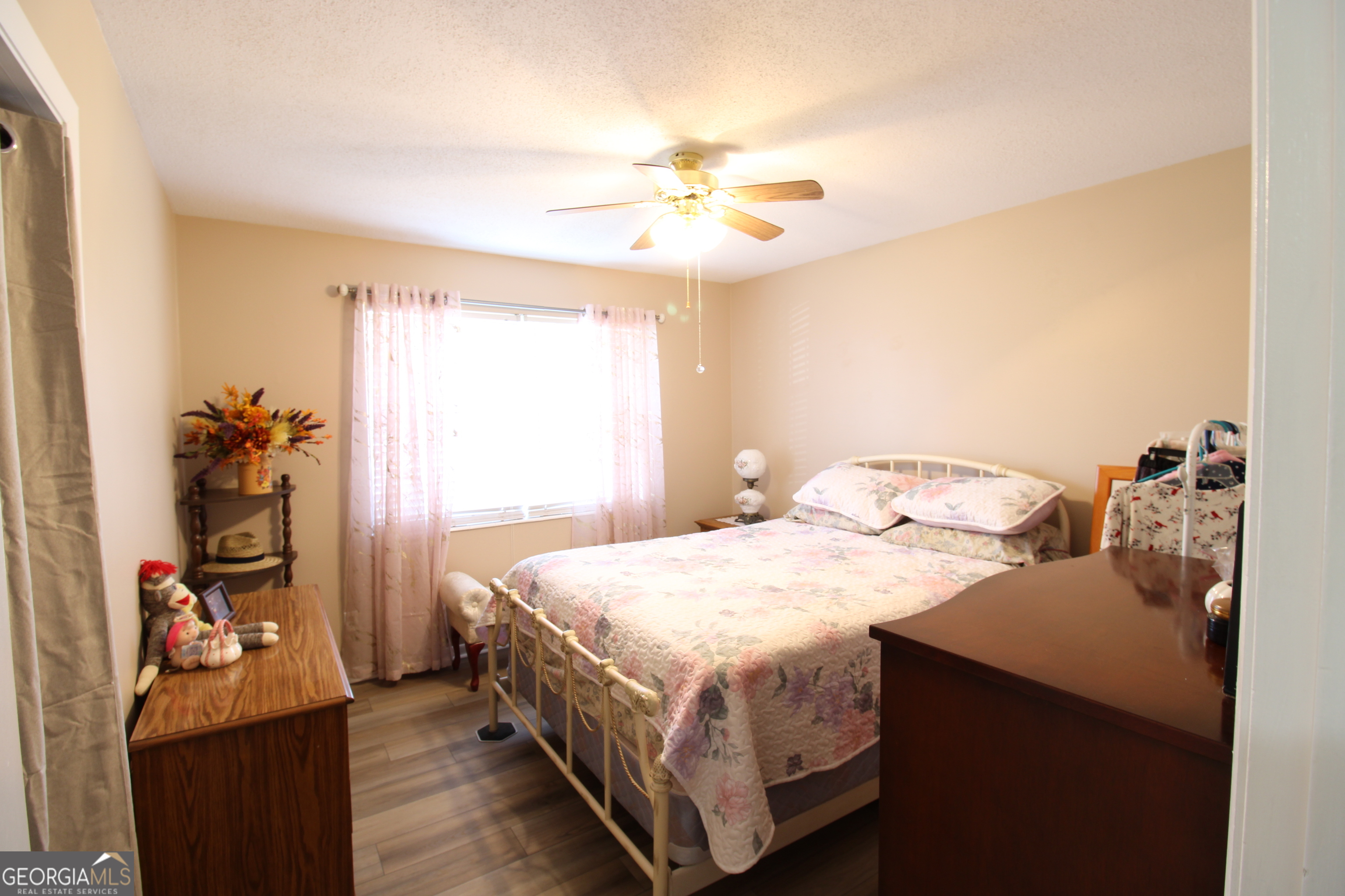2337 Spring Street Waycross, GA 31503 - Photo 24 of 28 a bedroom with a bed and a chandelier