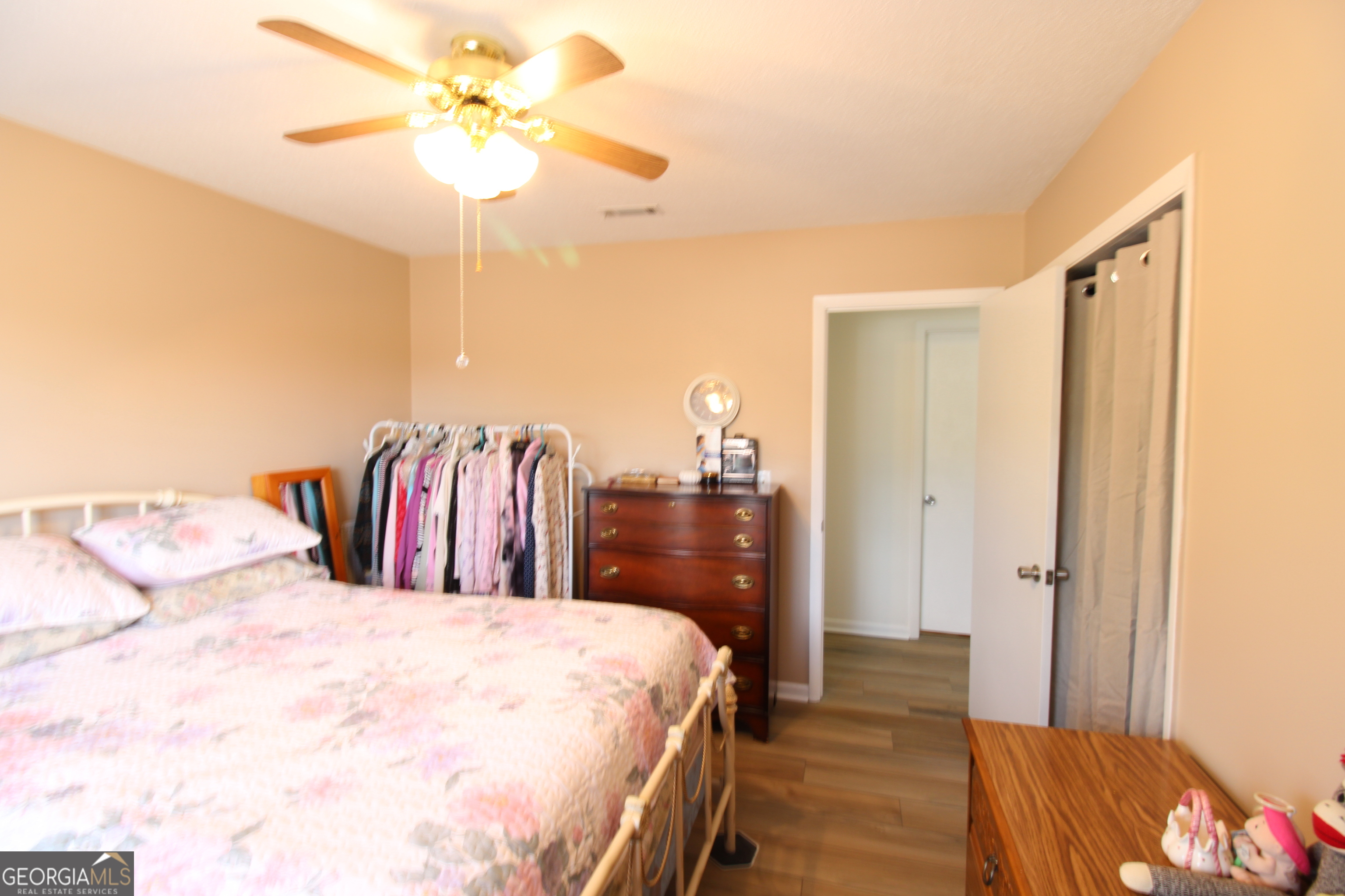 2337 Spring Street Waycross, GA 31503 - Photo 25 of 28 a bed room with a bed and a chandelier