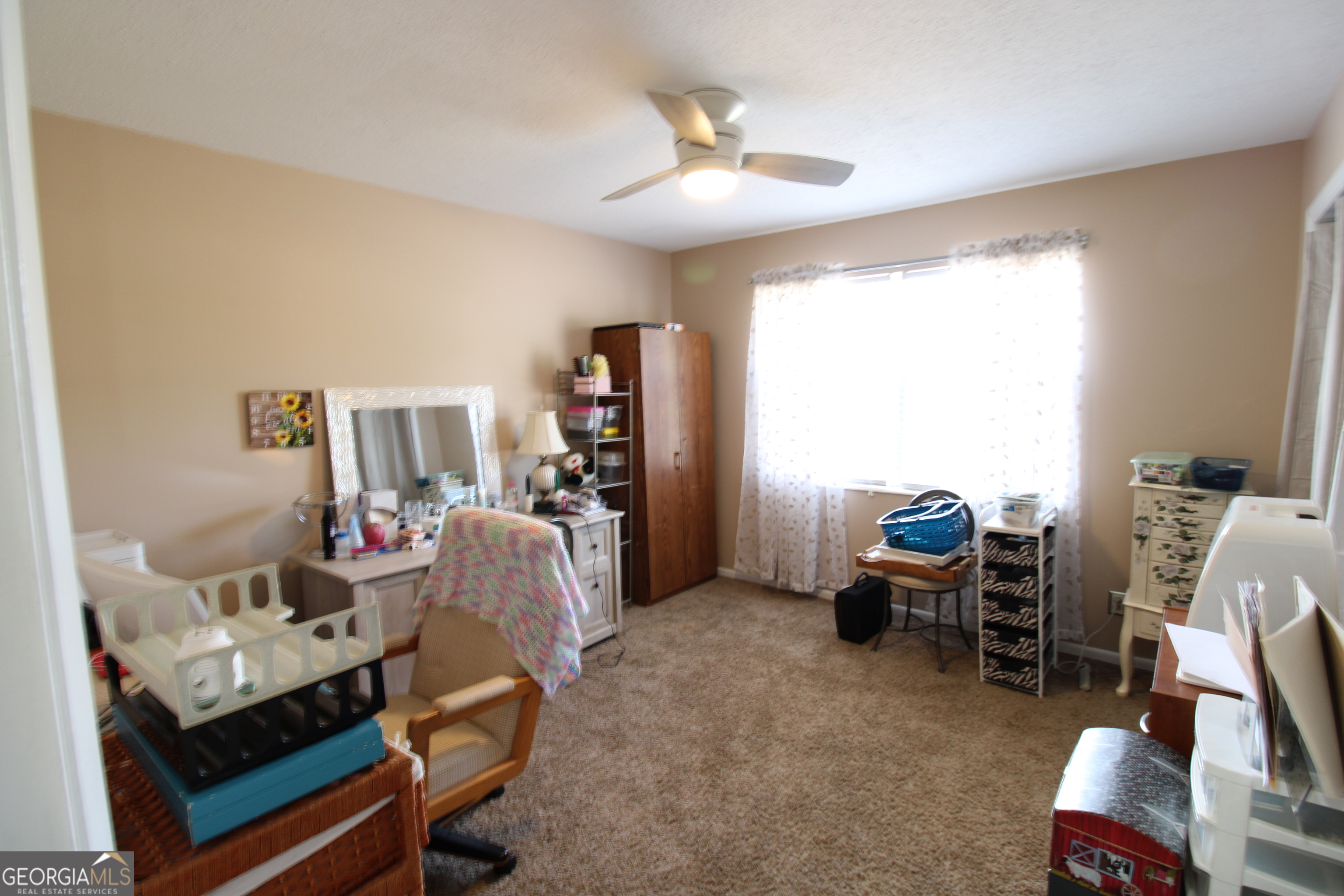 2337 Spring Street Waycross, GA 31503 - Photo 26 of 28 a living room with furniture and a chandelier