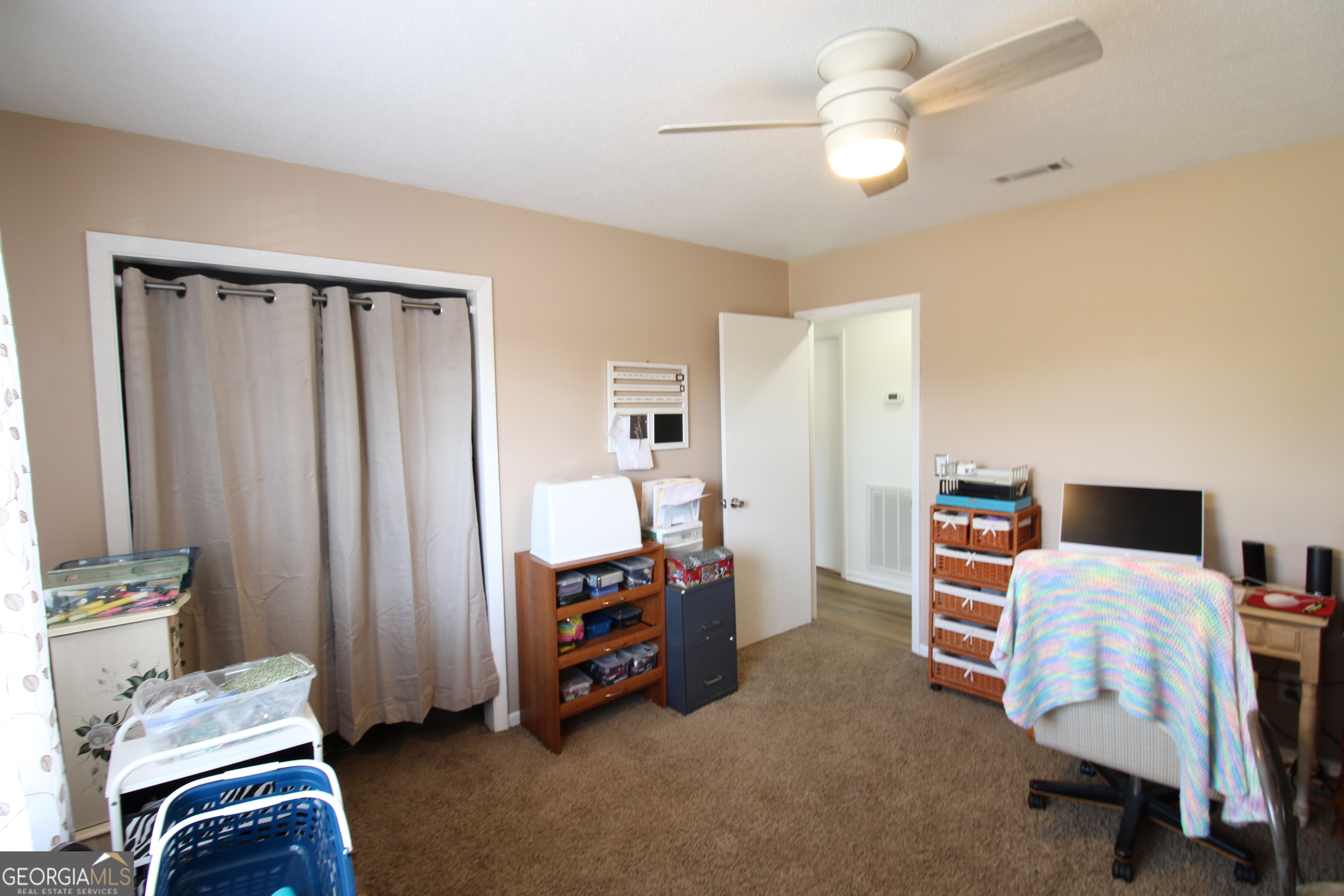 2337 Spring Street Waycross, GA 31503 - Photo 27 of 28 a room that has a bed and a chair in it