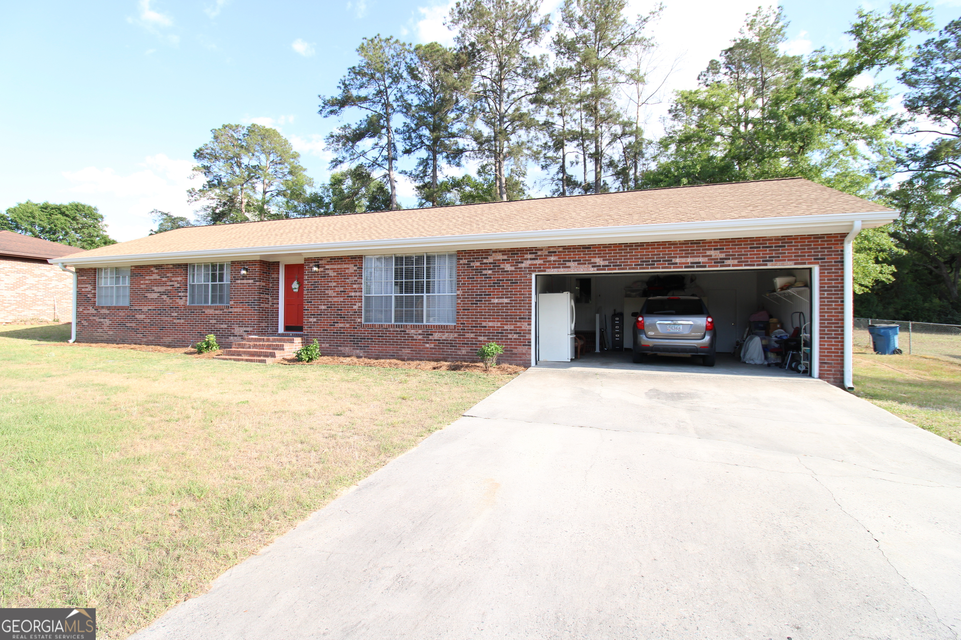 2337 Spring Street Waycross, GA 31503 - Photo 3 of 28 a front view of a house with a yard and a fireplace