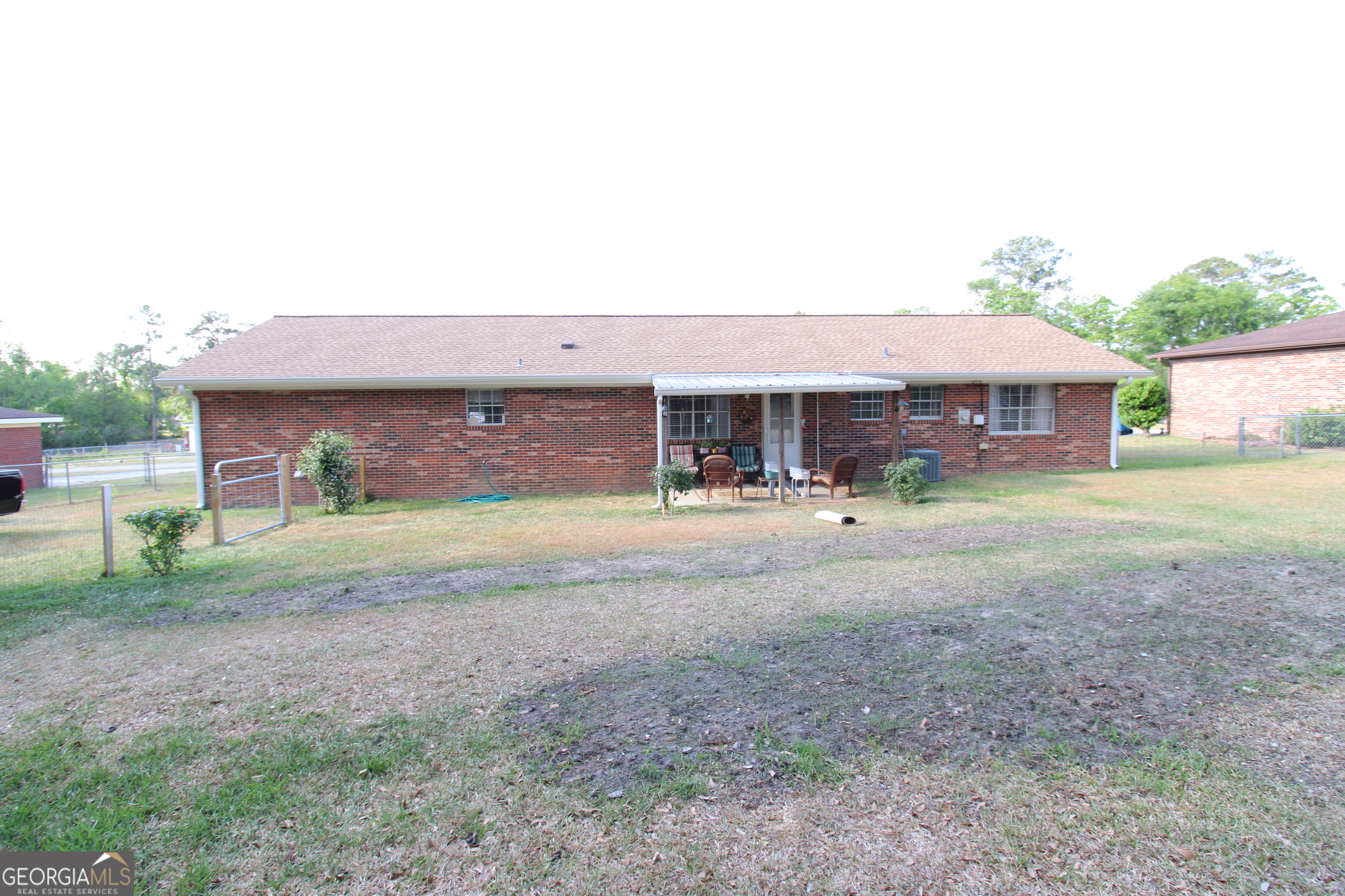 2337 Spring Street Waycross, GA 31503 - Photo 4 of 28 a front view of a house with garden