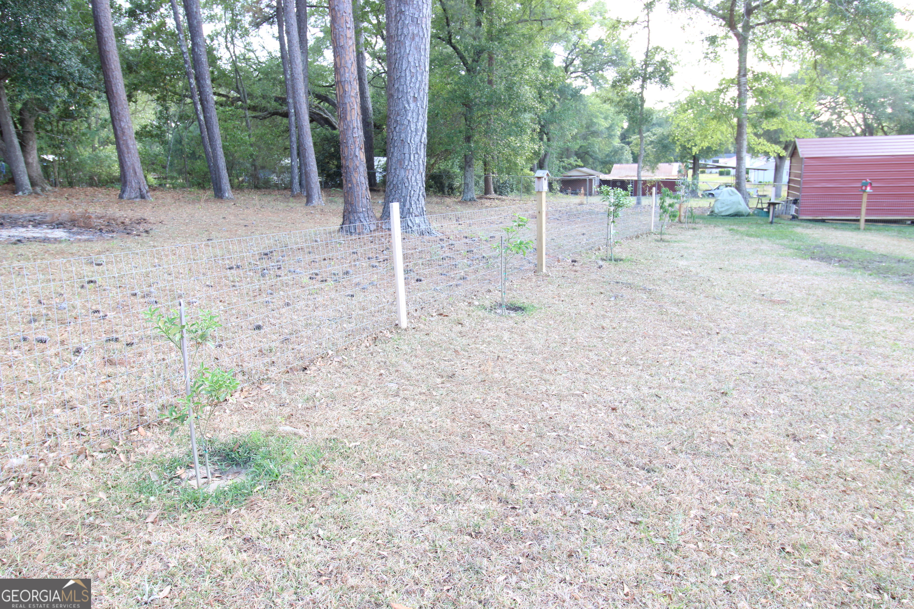 2337 Spring Street Waycross, GA 31503 - Photo 7 of 28 a view of backyard with a table and chairs