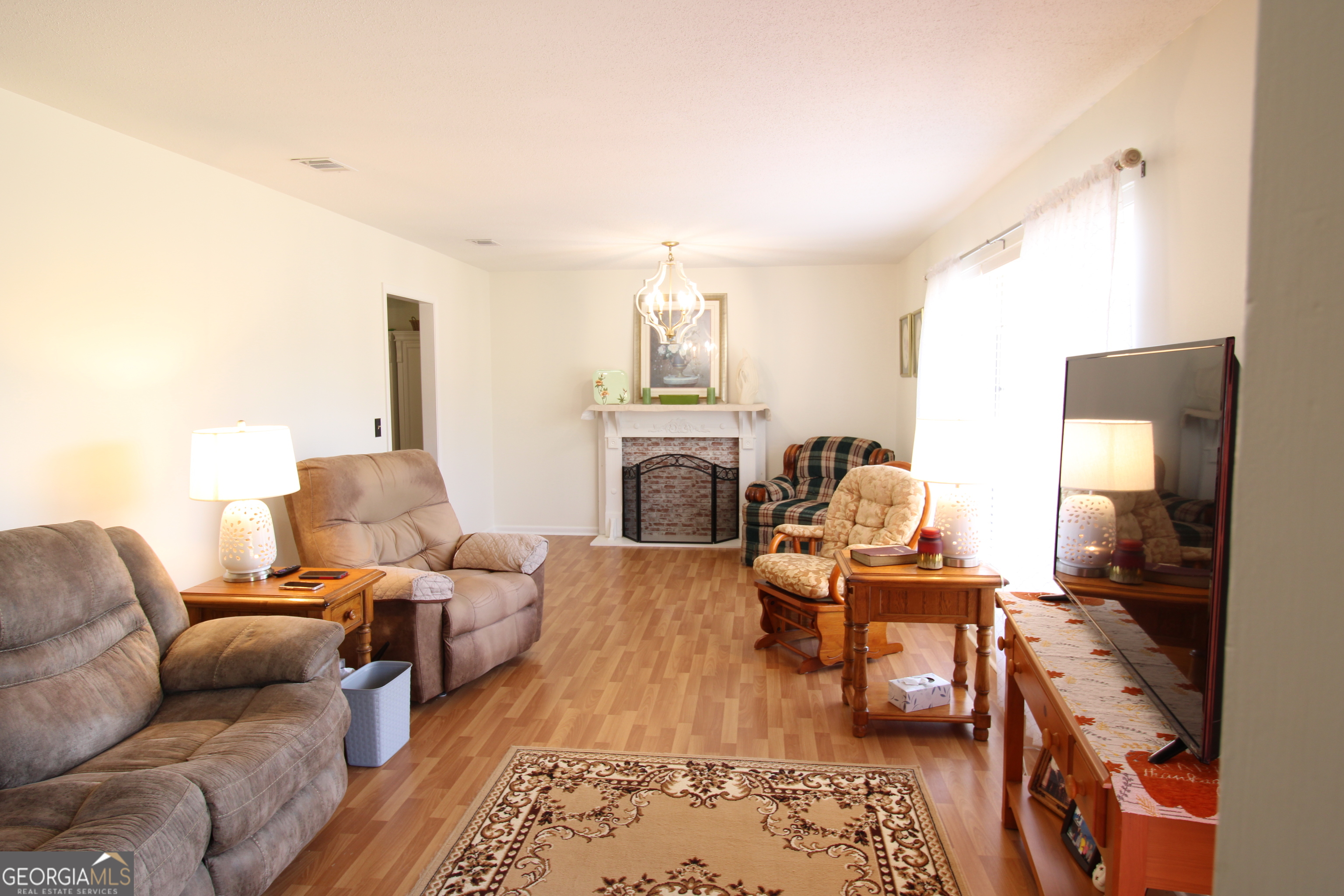 2337 Spring Street Waycross, GA 31503 - Photo 9 of 28 a living room with furniture fireplace and a table