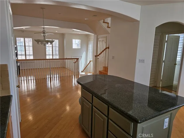 a kitchen with stainless steel appliances granite countertop a sink a refrigerator and a stove