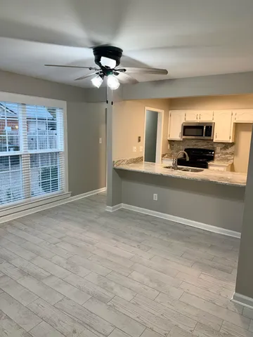 a view of a kitchen with a sink and dishwasher cabinets