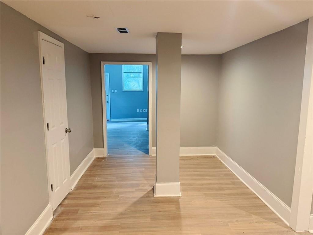 4330 Stonewall Tell Road Atlanta, GA 30349 - Photo 35 of 39 a view of hallway with wooden floor