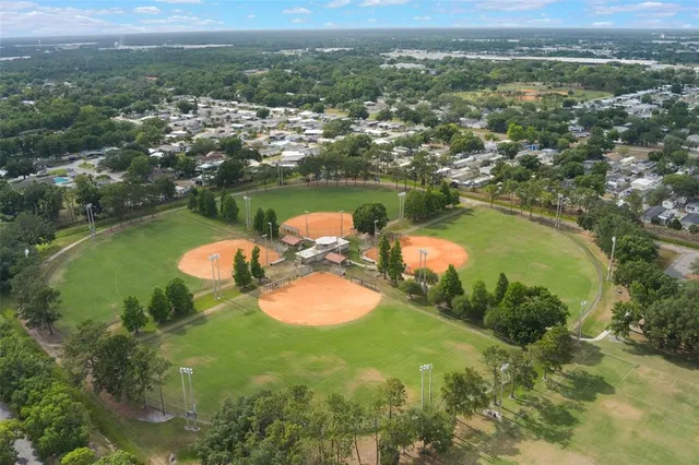 an aerial view of a residential houses with outdoor space and street view