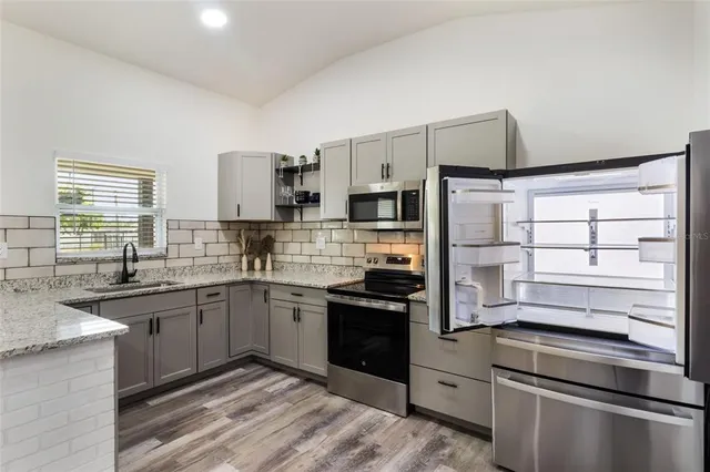 a kitchen with a sink stove and refrigerator