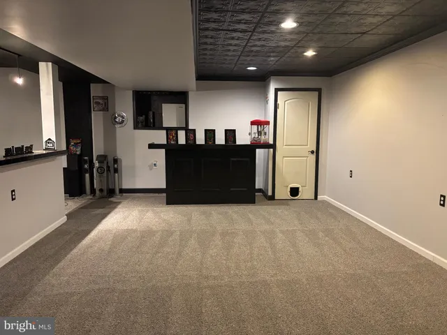 a spacious bedroom with a bed and a painting on the wall