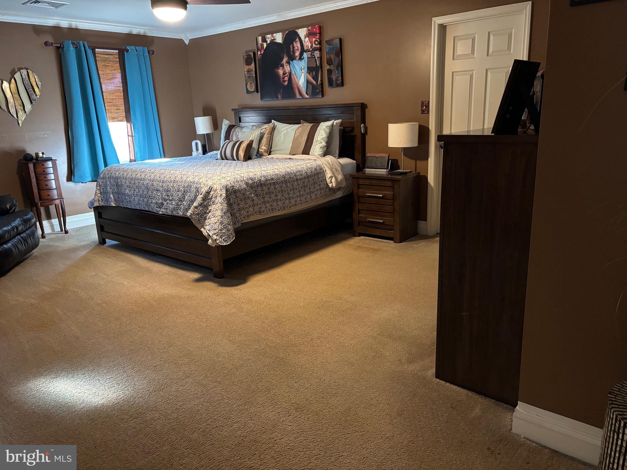 133 Steelton Road Sicklerville, NJ 08081 - Photo 25 of 35 a spacious bedroom with a bed and a painting on the wall