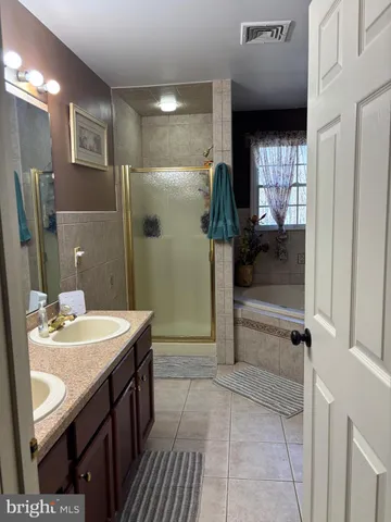 a bedroom with a bed and a mirror