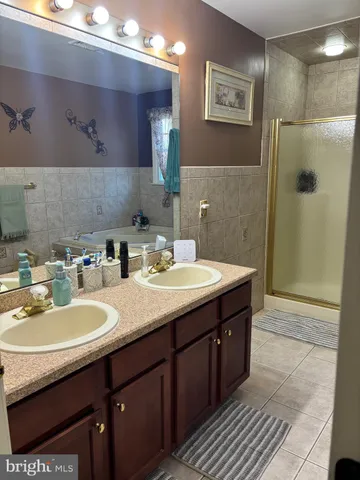 a bedroom with a bed and a flat tv screen on dresser