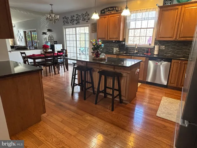 a dining room with furniture window and wooden floor