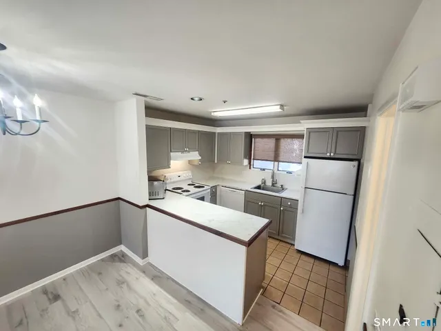 a kitchen with stainless steel appliances granite countertop a refrigerator sink and cabinets