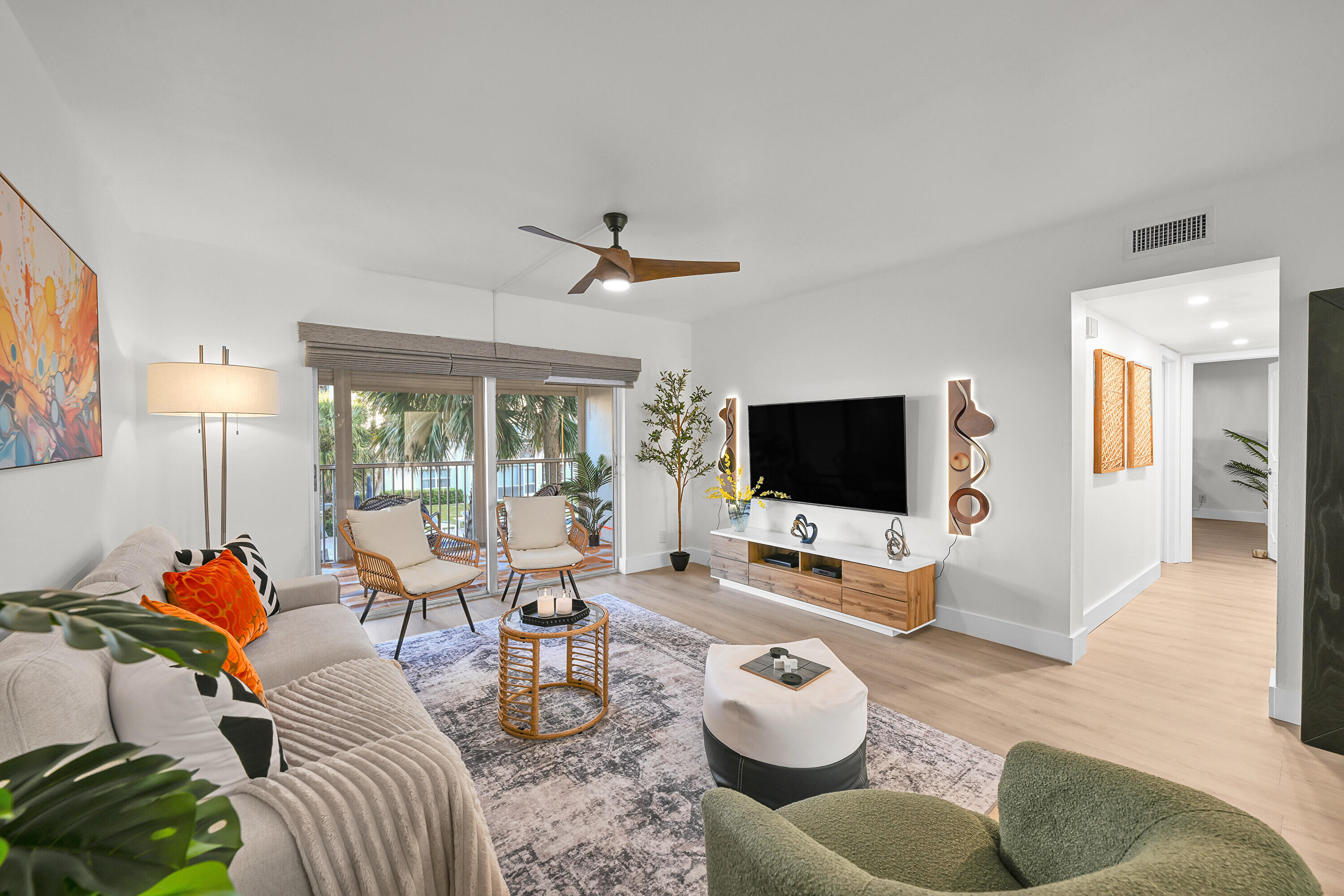 800 East Camino Real, Unit 204 Boca Raton, FL 33432 - Photo 11 of 39 a living room with furniture and a flat screen tv