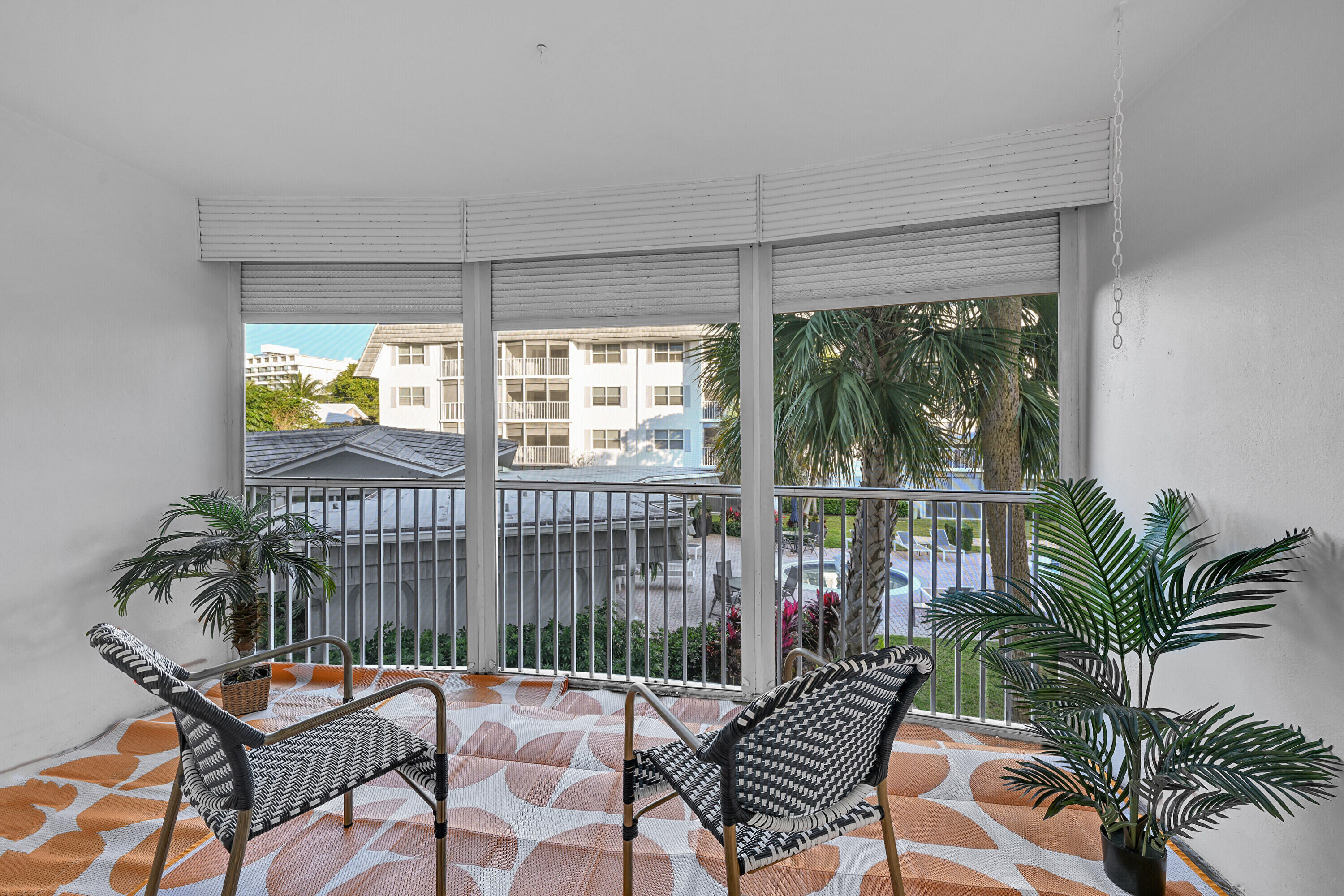 800 East Camino Real, Unit 204 Boca Raton, FL 33432 - Photo 12 of 39 a balcony with furniture and garden