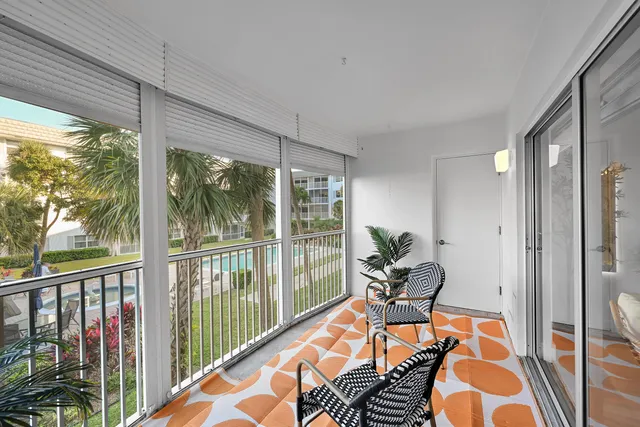 a living room filled with furniture and floor to ceiling window
