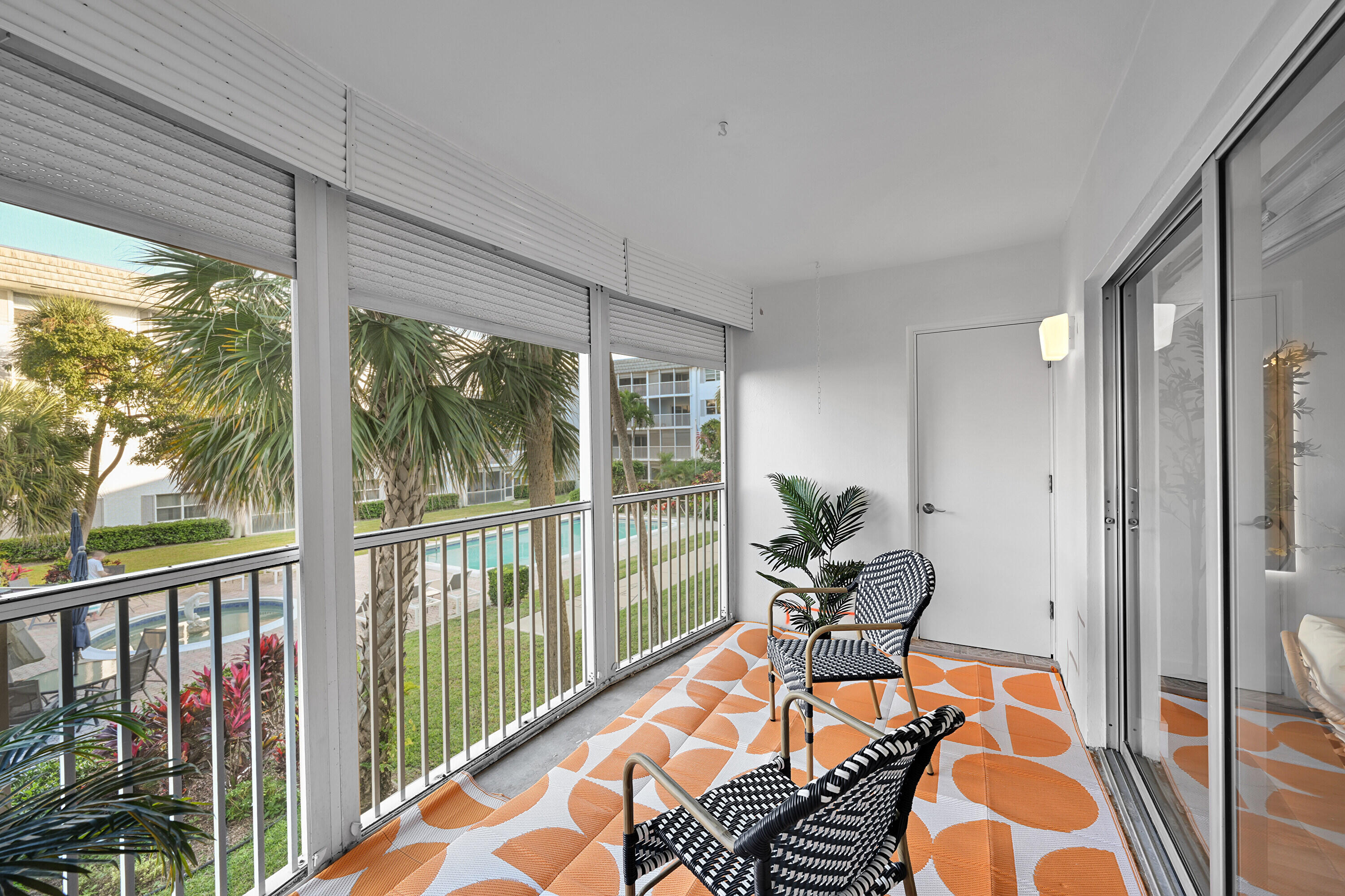 800 East Camino Real, Unit 204 Boca Raton, FL 33432 - Photo 13 of 39 a living room filled with furniture and floor to ceiling window