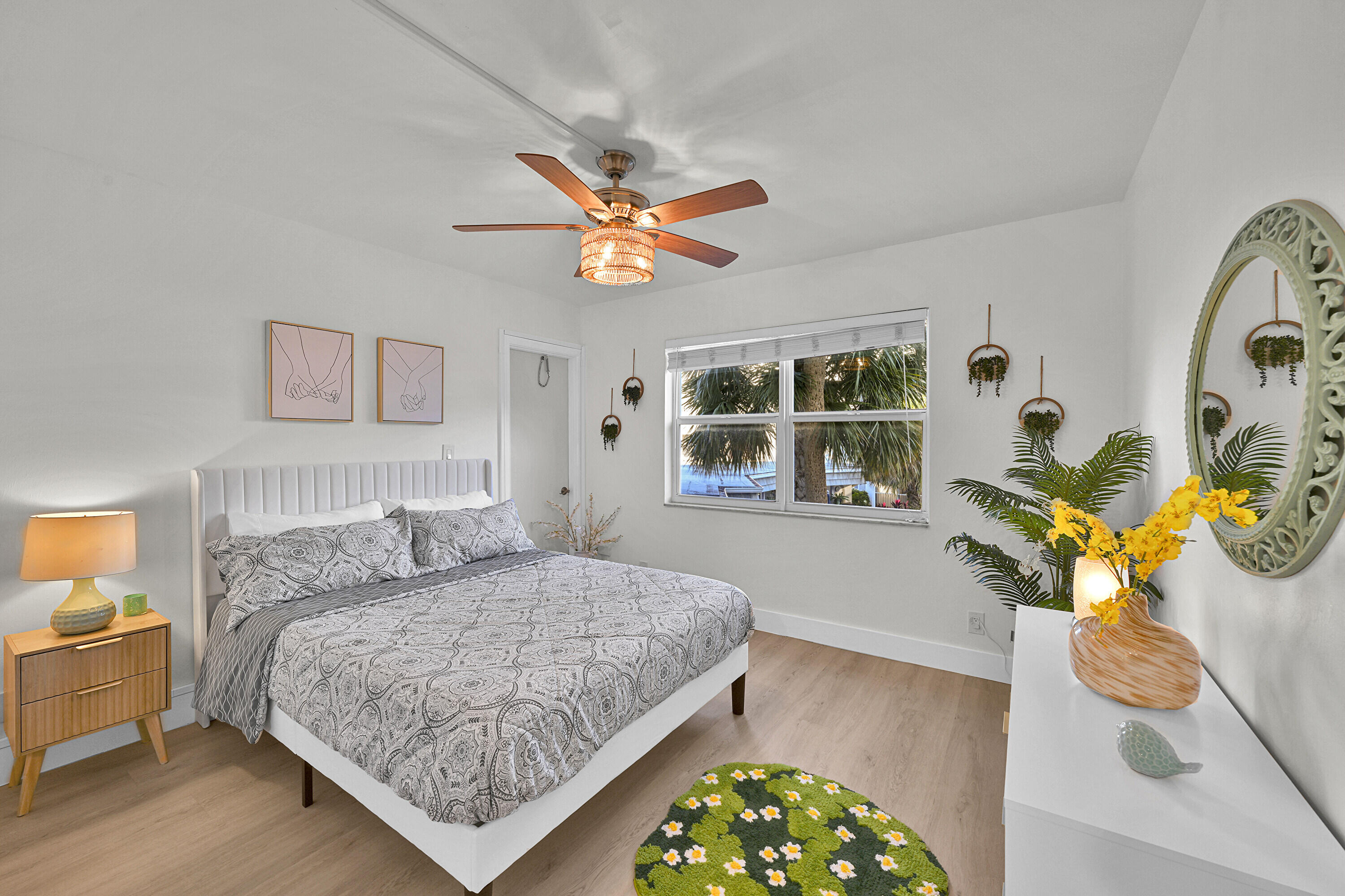 800 East Camino Real, Unit 204 Boca Raton, FL 33432 - Photo 15 of 39 a bedroom with a bed and a chandelier