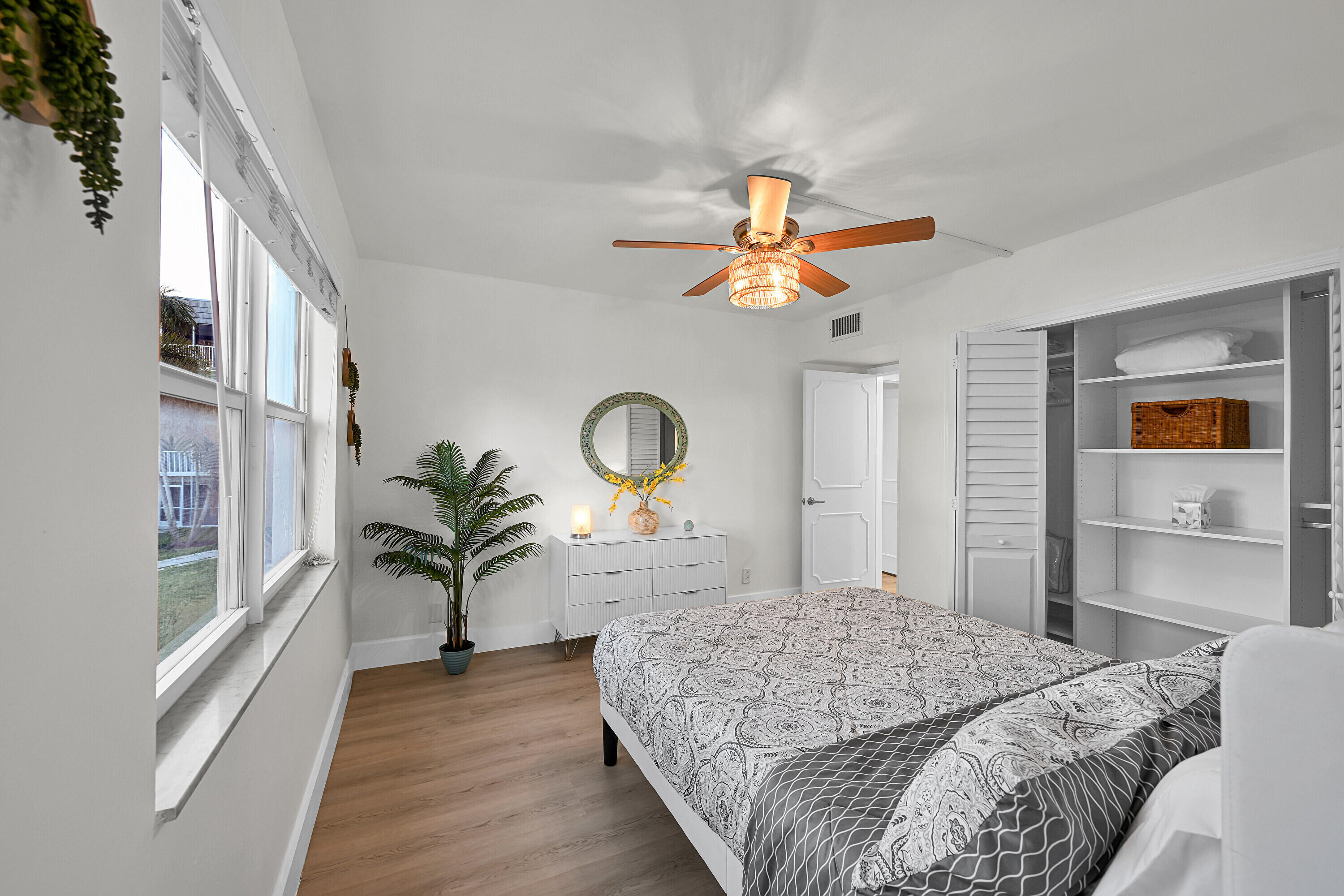 800 East Camino Real, Unit 204 Boca Raton, FL 33432 - Photo 17 of 39 a bedroom with a bed and a chandelier