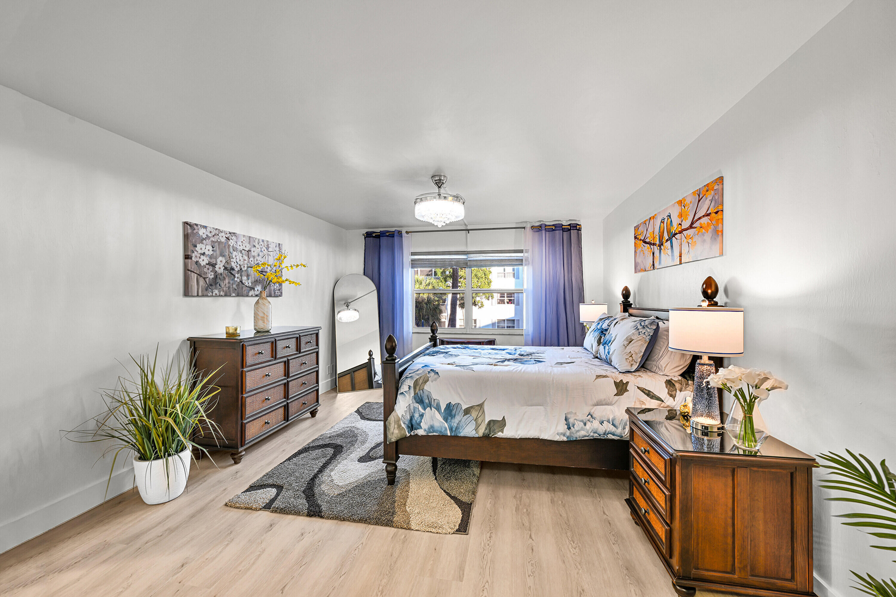 800 East Camino Real, Unit 204 Boca Raton, FL 33432 - Photo 20 of 39 a bedroom with a bed and wooden floor