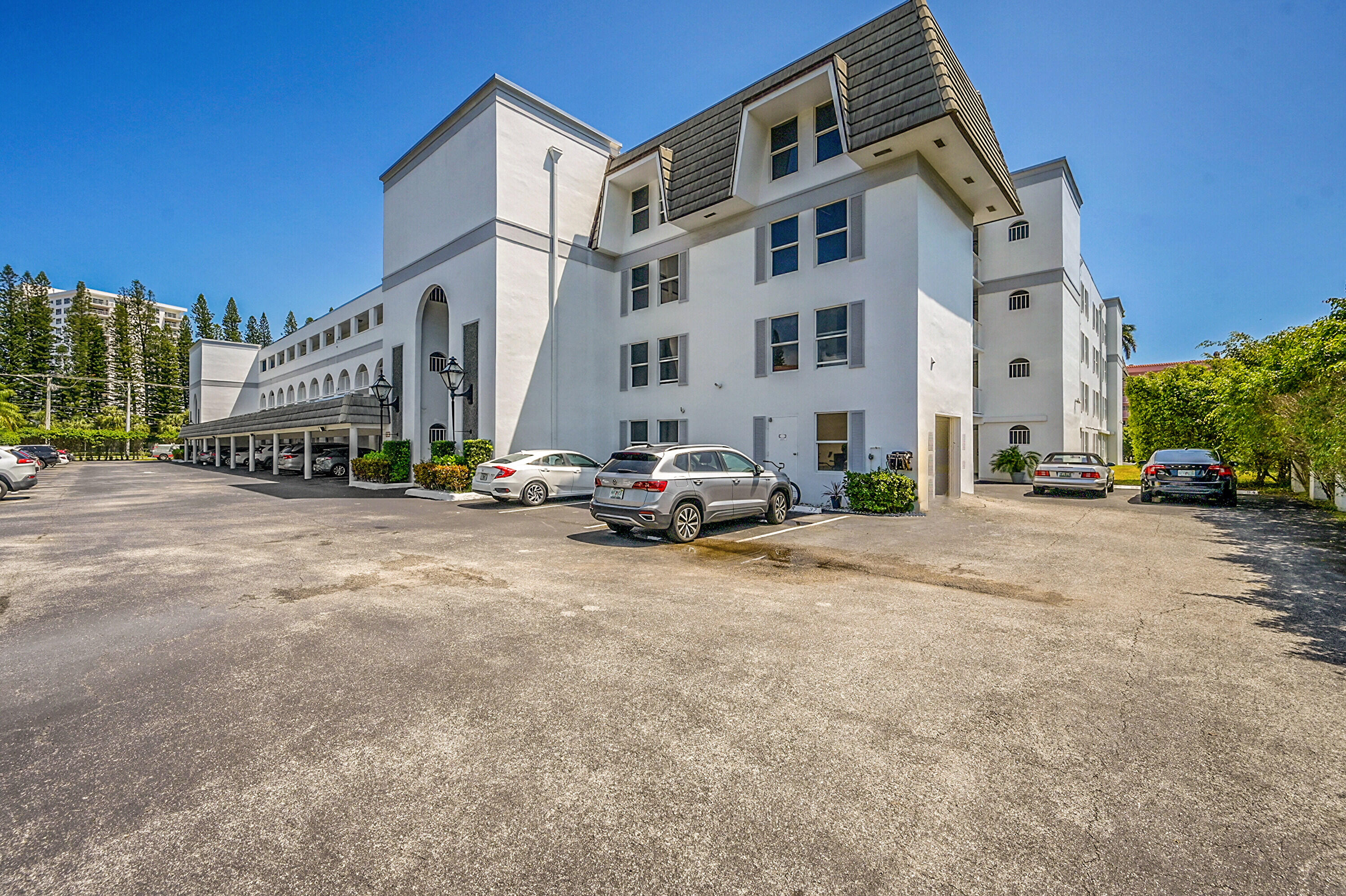 800 East Camino Real, Unit 204 Boca Raton, FL 33432 - Photo 2 of 39 a car parked in front of a building