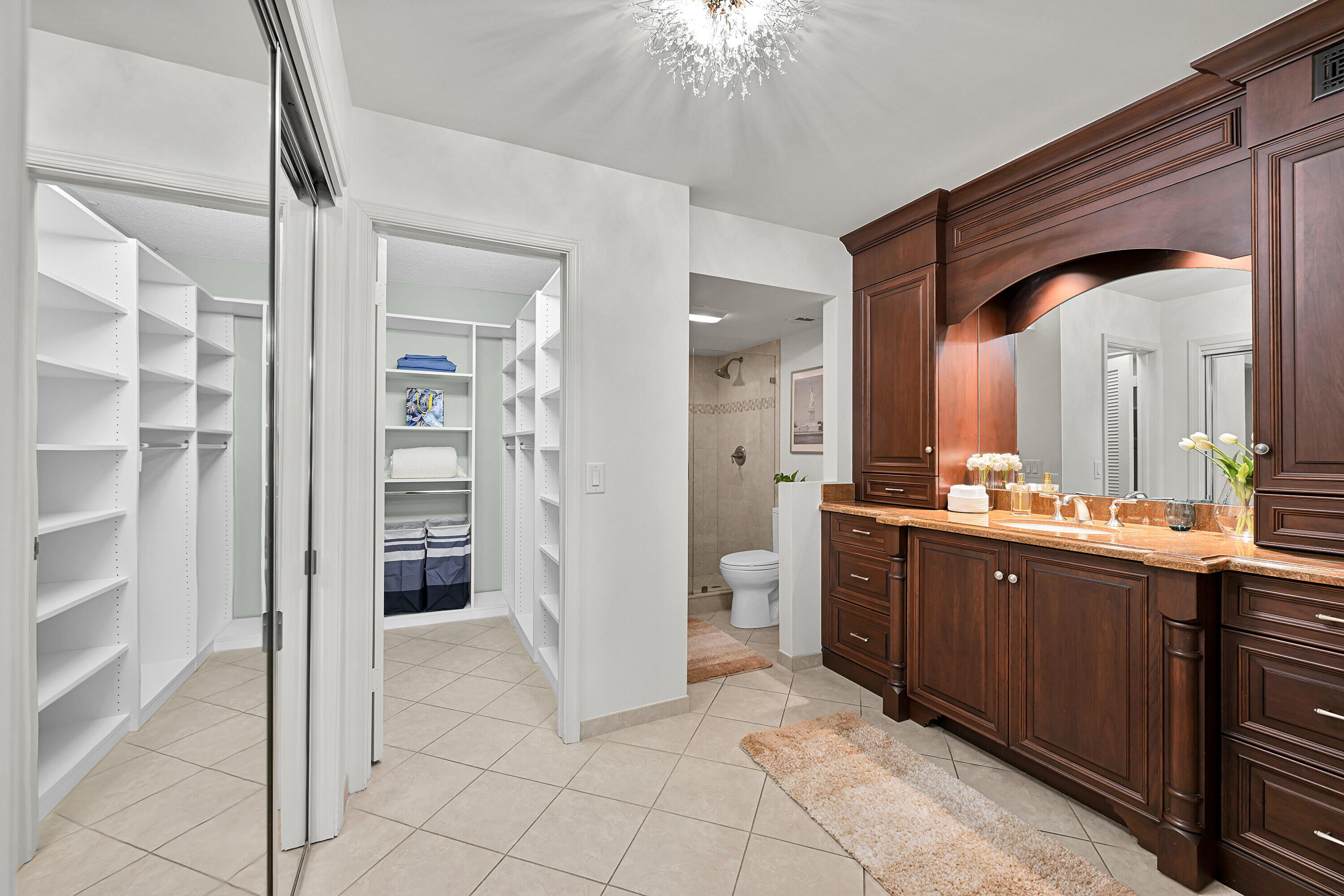 800 East Camino Real, Unit 204 Boca Raton, FL 33432 - Photo 22 of 39 a spacious bathroom with a double vanity sink and a mirror