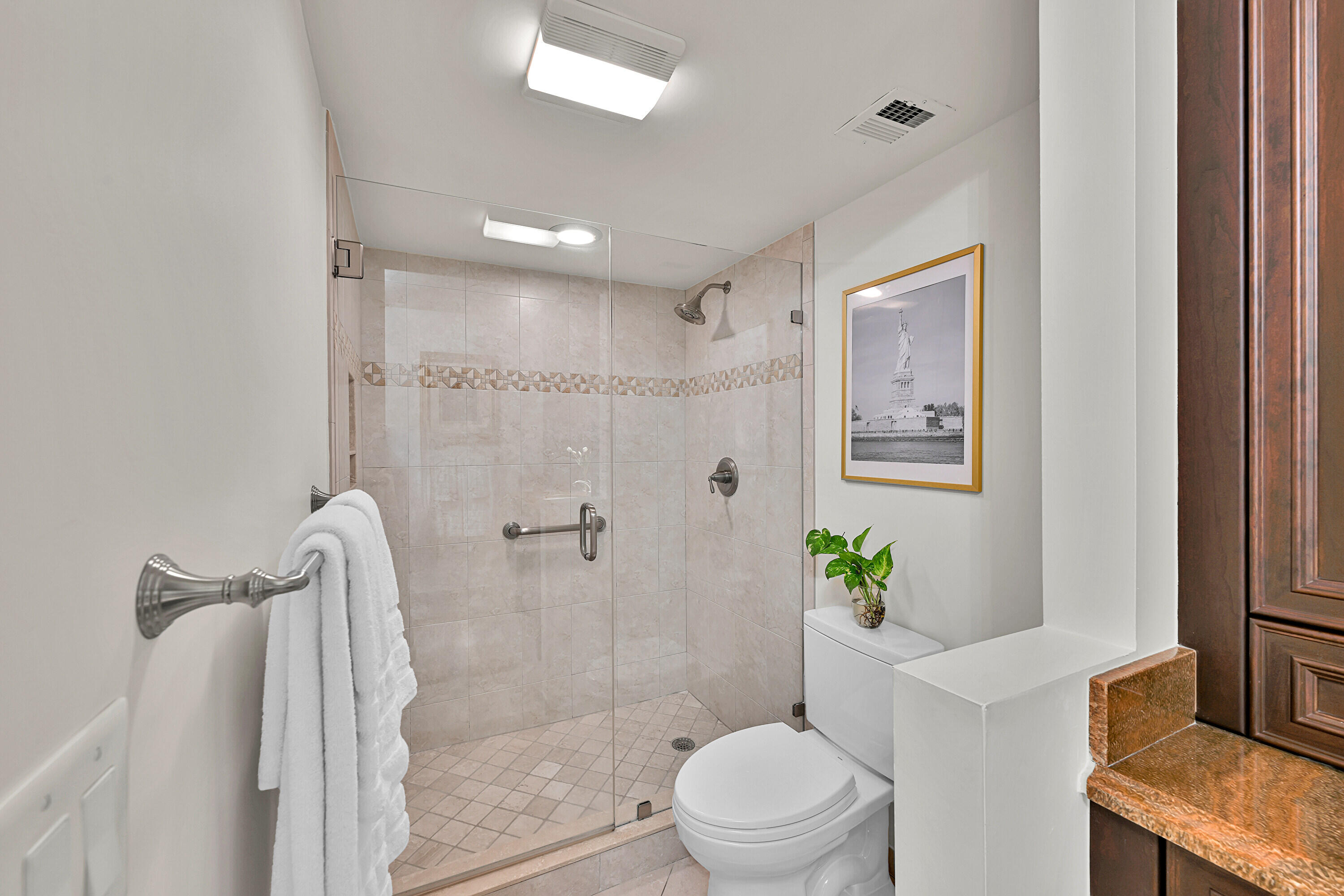 800 East Camino Real, Unit 204 Boca Raton, FL 33432 - Photo 24 of 39 a bathroom with a shower a toilet and a shower