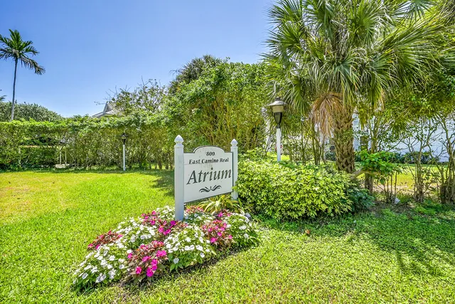 a sign that is in front of flowers
