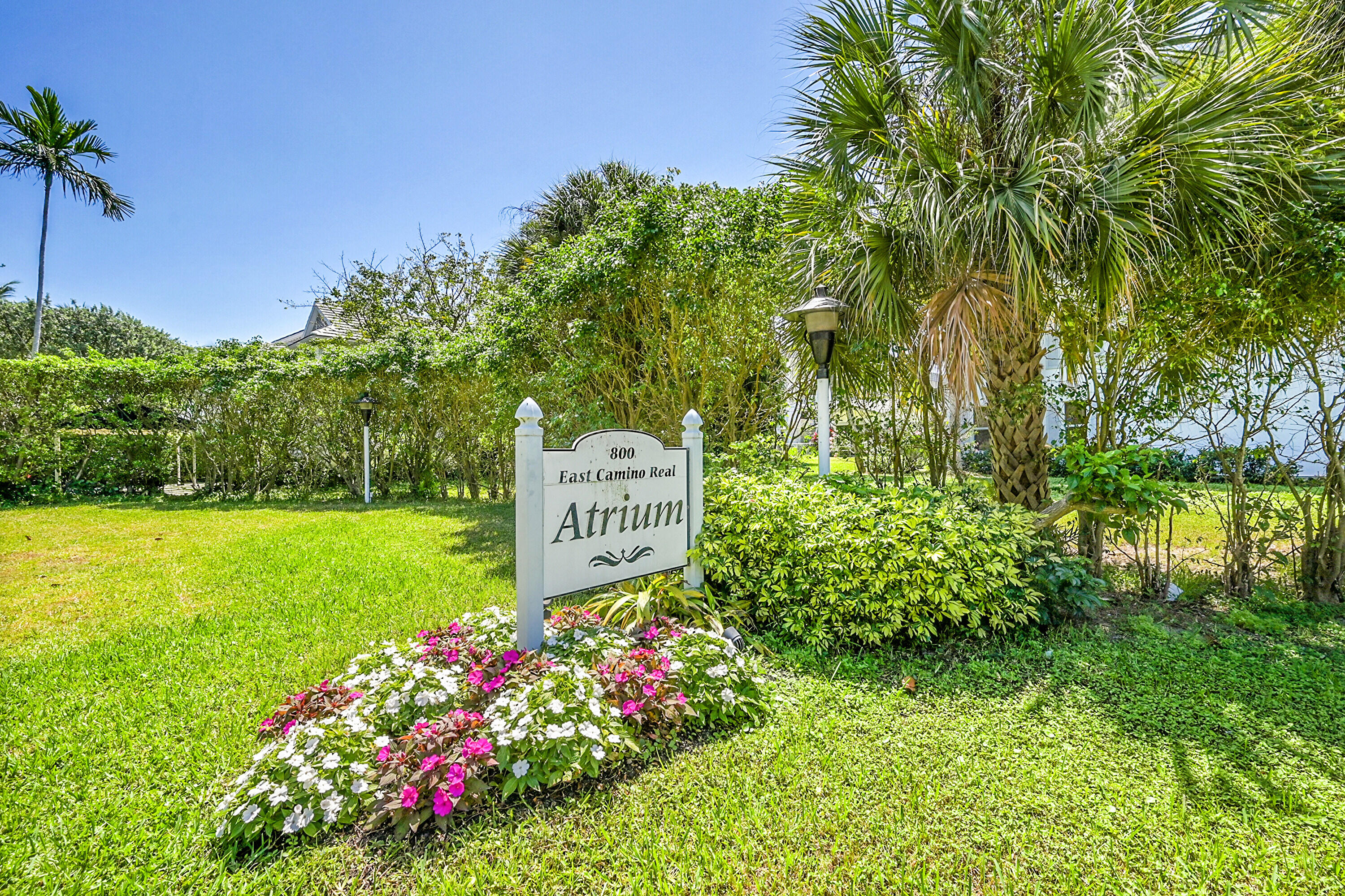800 East Camino Real, Unit 204 Boca Raton, FL 33432 - Photo 25 of 39 a sign that is in front of flowers