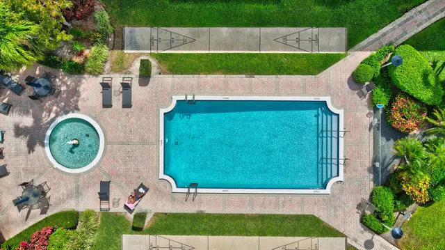 a swimming pool with outdoor seating and yard